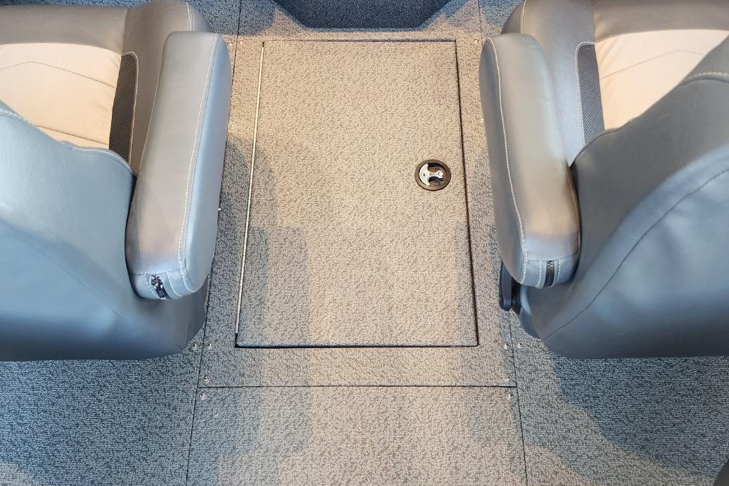 Interior of a 2023 Lowe boat featuring two gray seats and a central storage compartment.