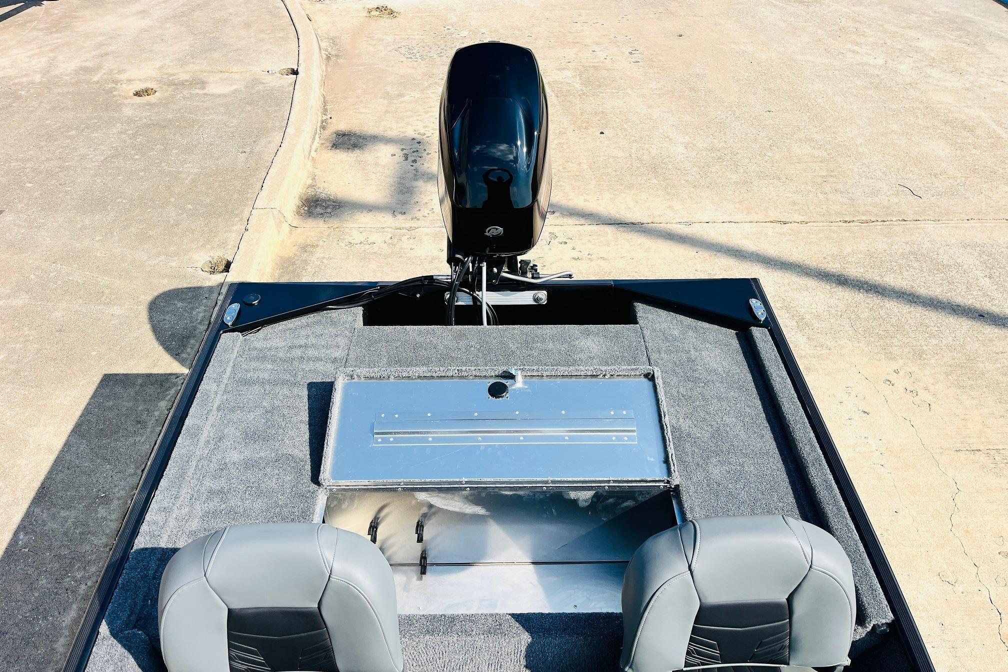 2026 Tracker Bass Tracker Classic XL boat interior with motor, gray seats, and storage compartment.