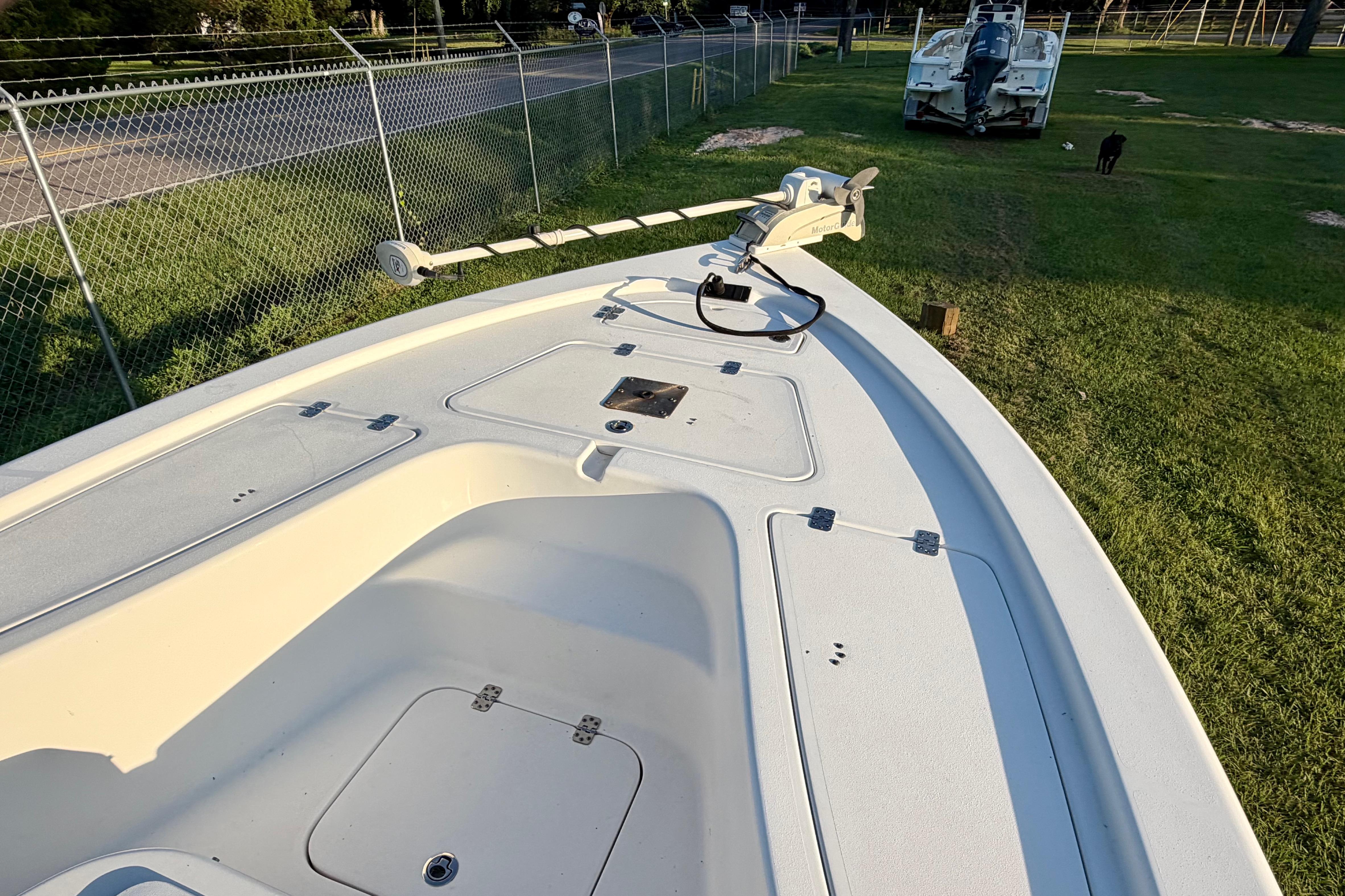 2018 Sea Pro 208 Bay boat deck with trolling motor, parked on grass.