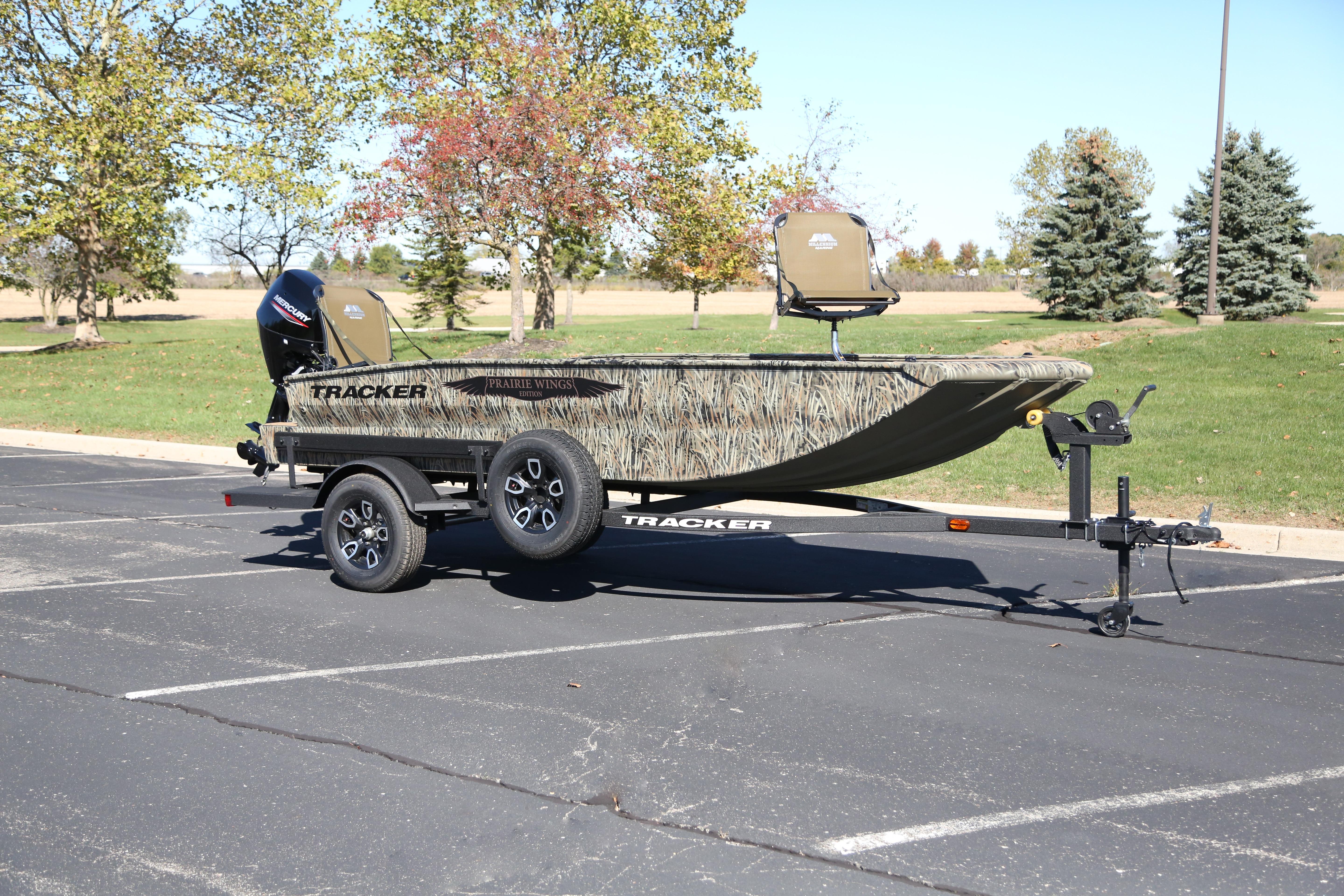 2026 Tracker Grizzly 1650 T Prairie Wings Edition boat on trailer in parking lot.