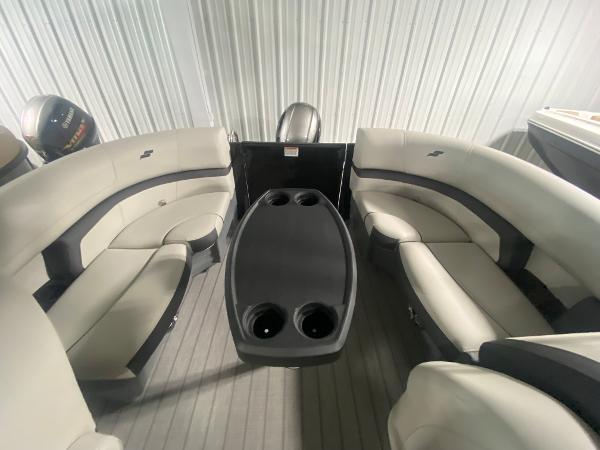 2024 Starcraft EXS 1 boat interior with cushioned seating and center table.