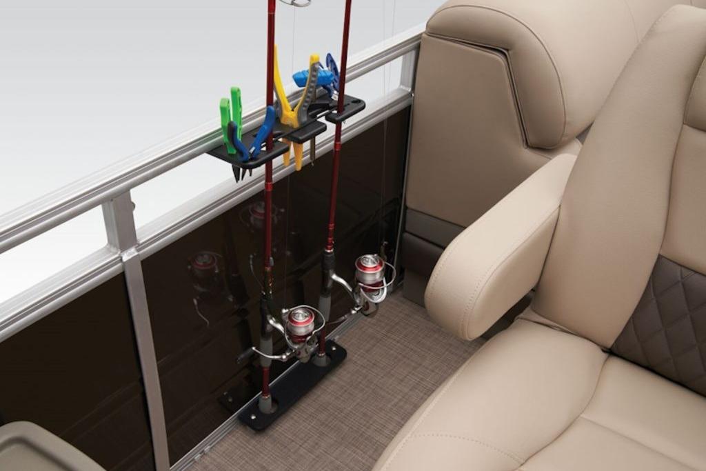 2025 Sun Tracker Sportfish™ 24 XP3 interior with fishing rod holders and beige seating.