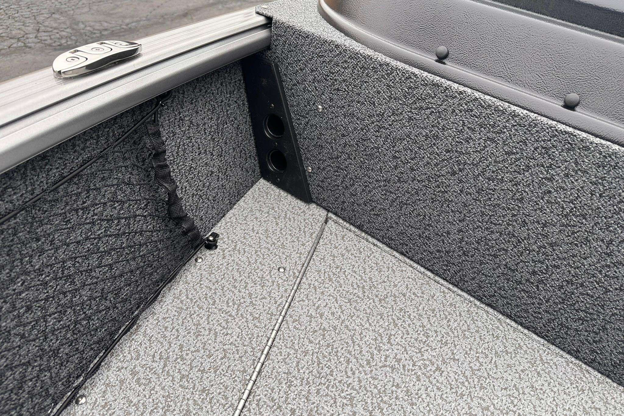 2026 Lund 1775 Impact XS Sport boat interior with textured flooring and storage compartments.
