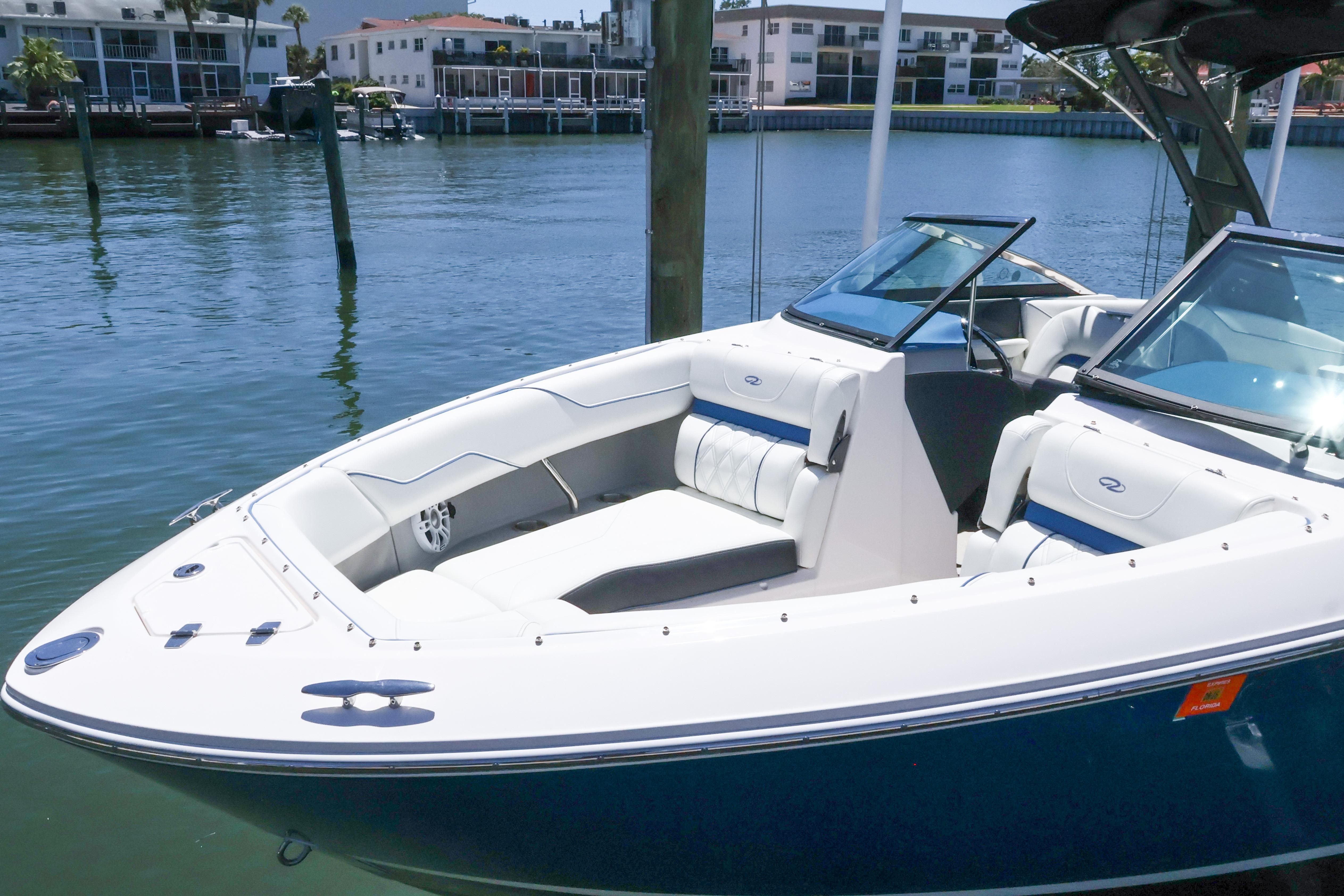 2020 Regal LX4 boat docked in a marina with modern seating.