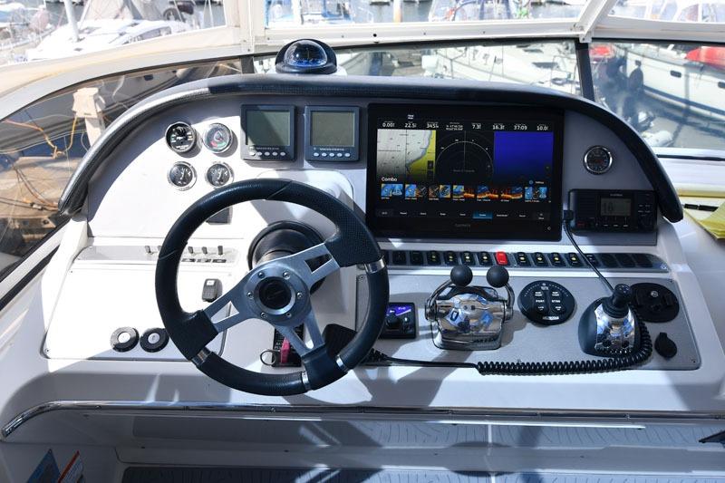Dashboard of a 2008 Carver 43 Super Sport yacht with navigation controls and displays.