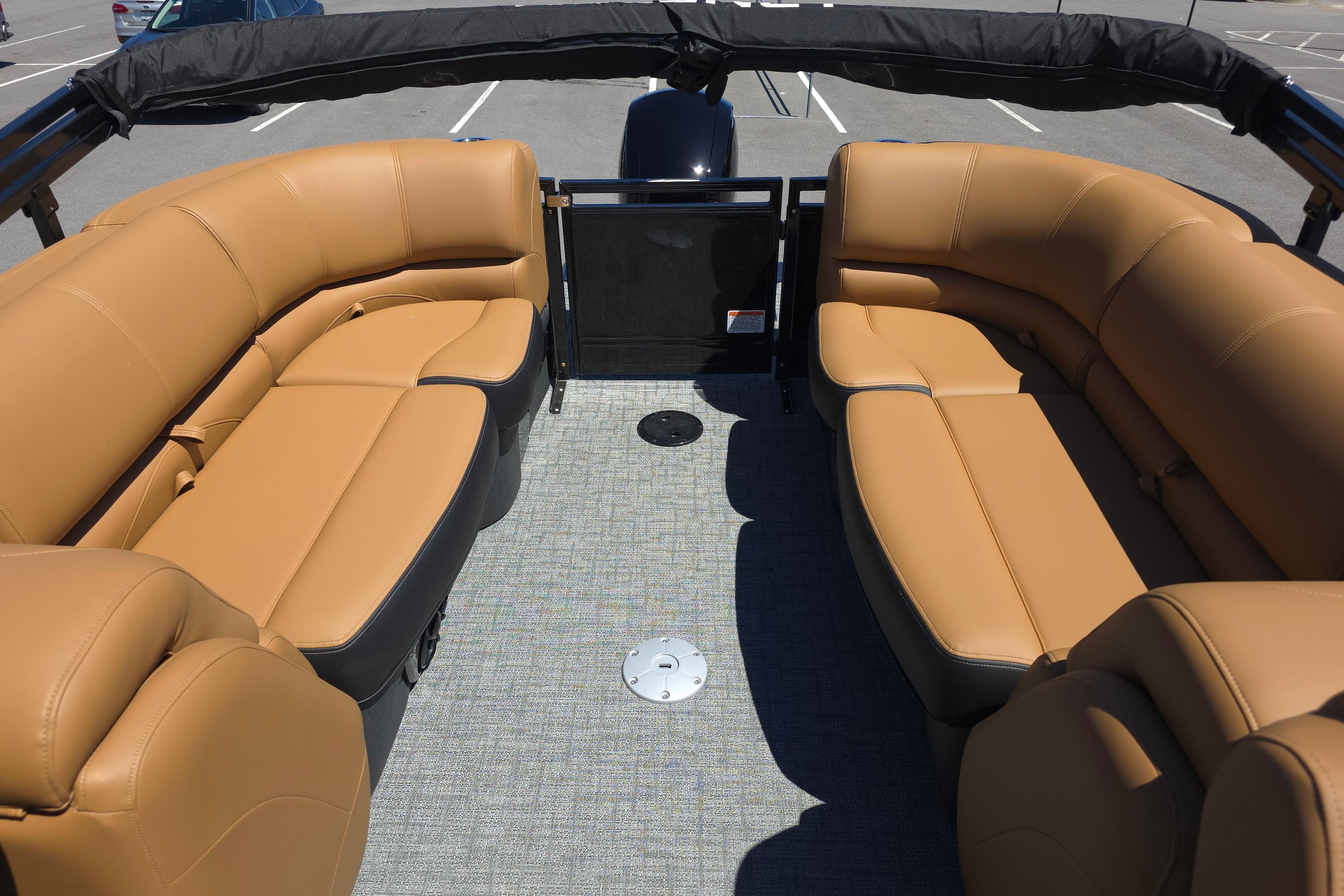 Luxurious seating on 2026 Regency 230 DL pontoon boat, featuring tan upholstery and spacious layout.