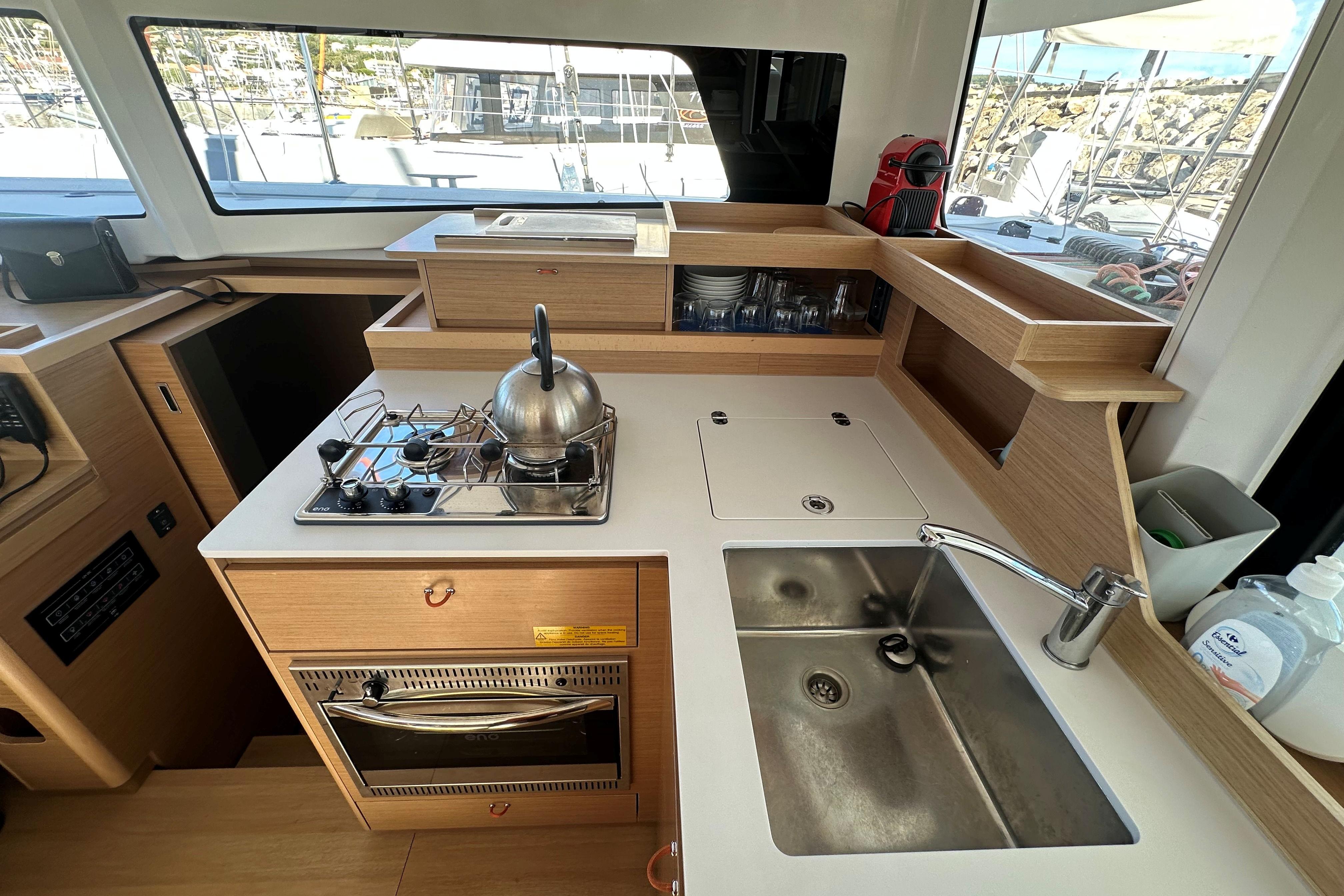 Modern kitchen in 2025 Excess 11 yacht with stove, sink, and storage.