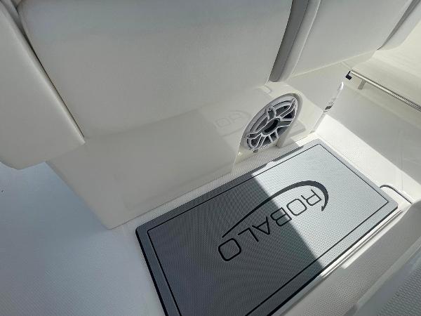 2023 Robalo R270 boat interior with branded mat and speaker.