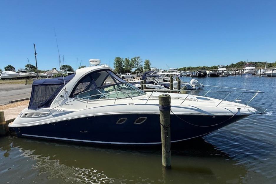 2008 Sea Ray Sundancer 330 yacht docked at a marina under clear blue skies.