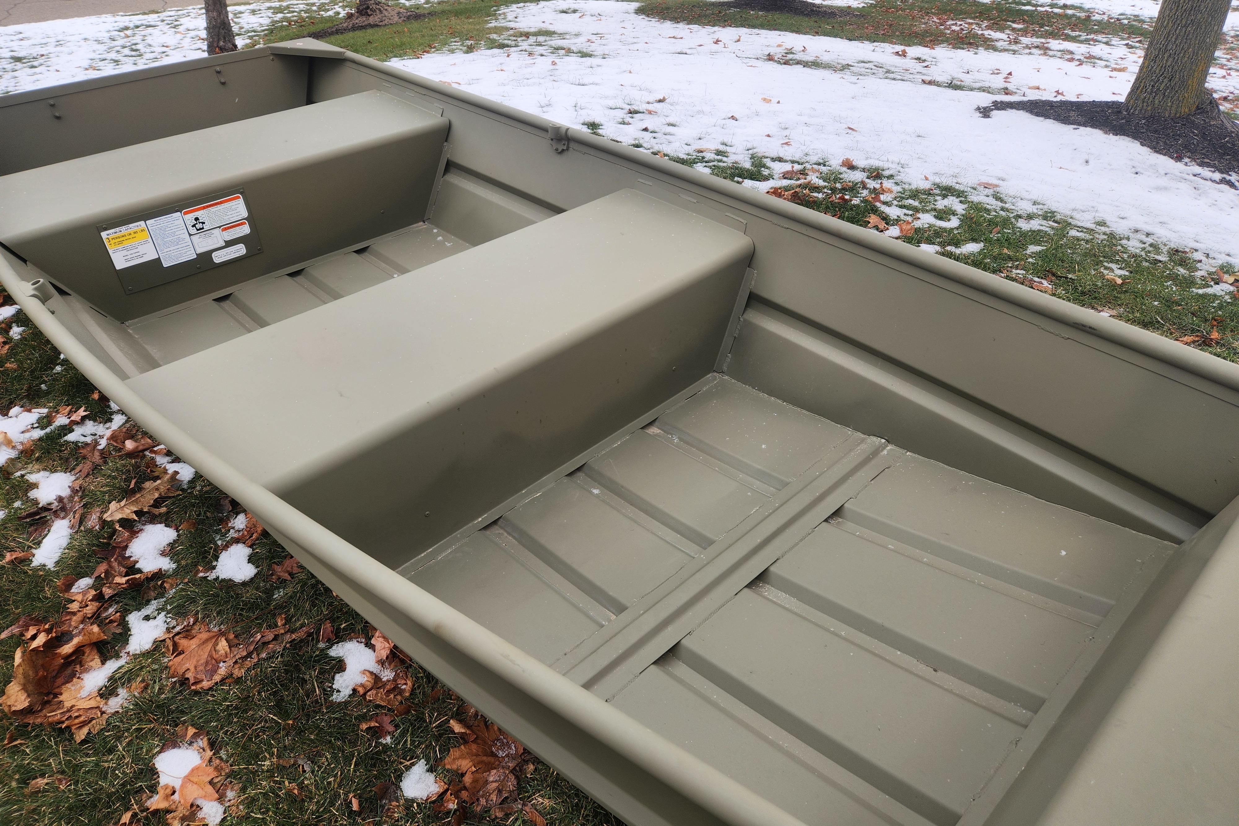 2026 Tracker Grizzly 12 Jon boat on snowy grass with fallen leaves.