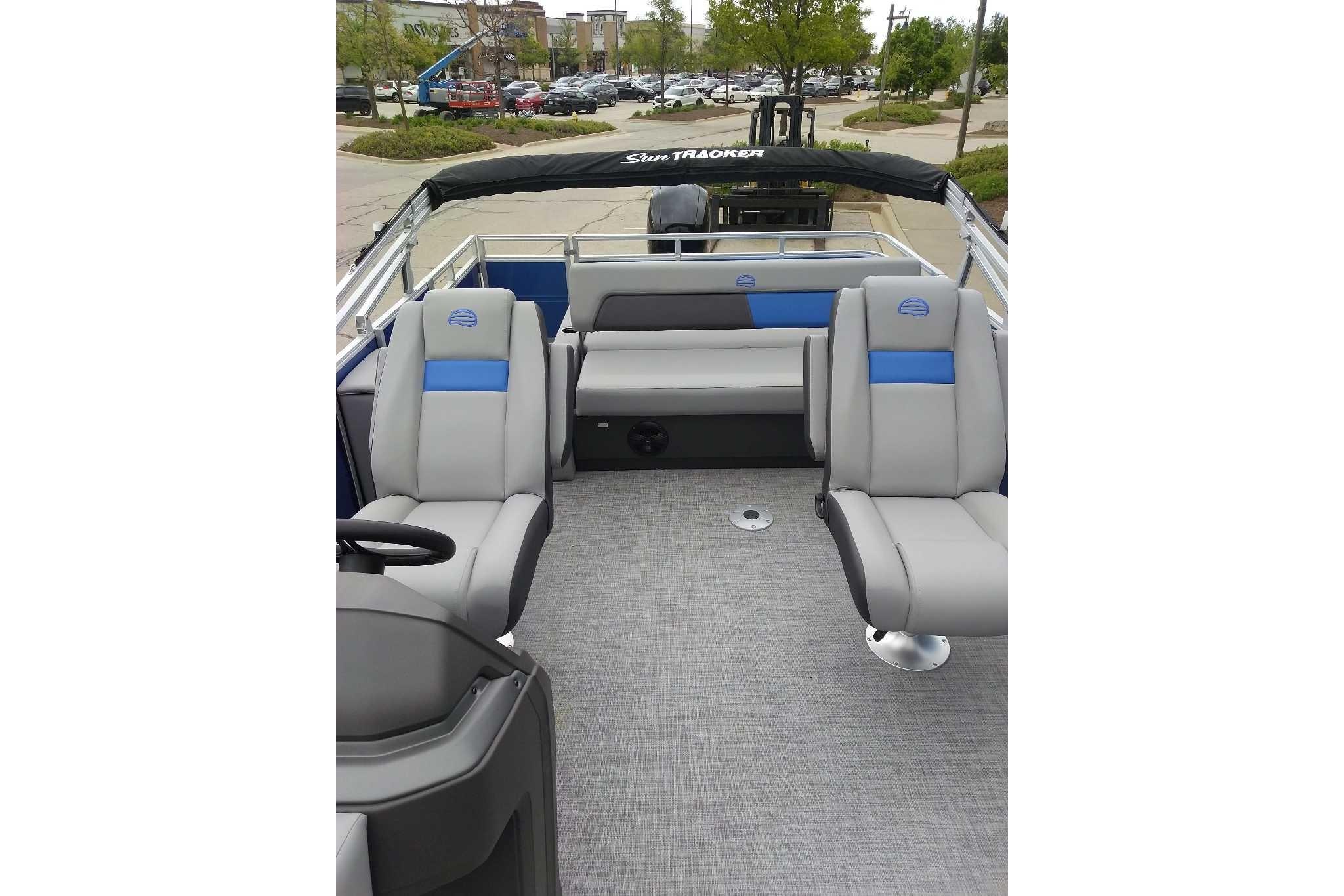 2026 Sun Tracker Party Barge 22 RF DLX interior with gray and blue seating.