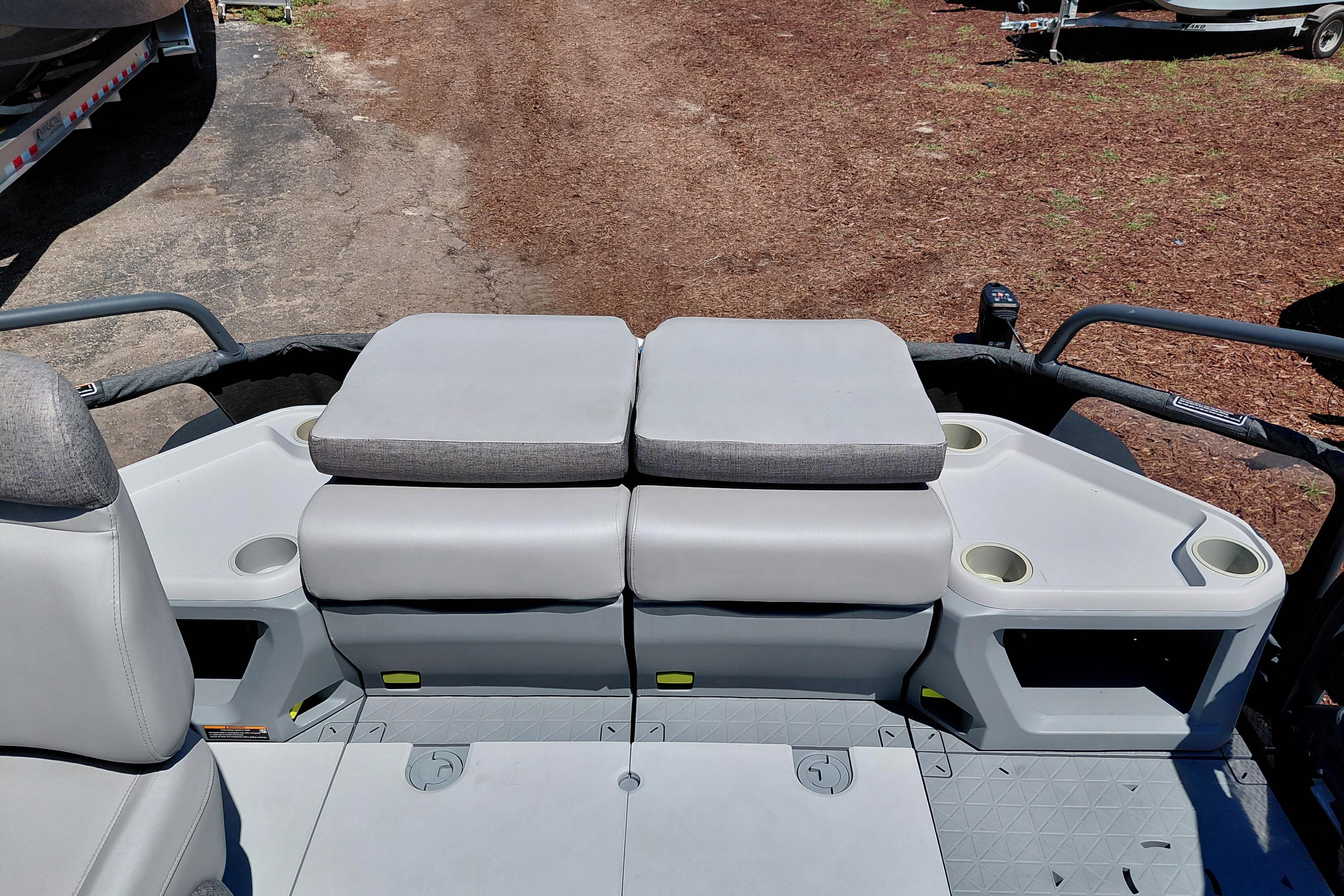 2024 Sea-Doo Switch Cruise 18 interior with cushioned seating and cup holders.