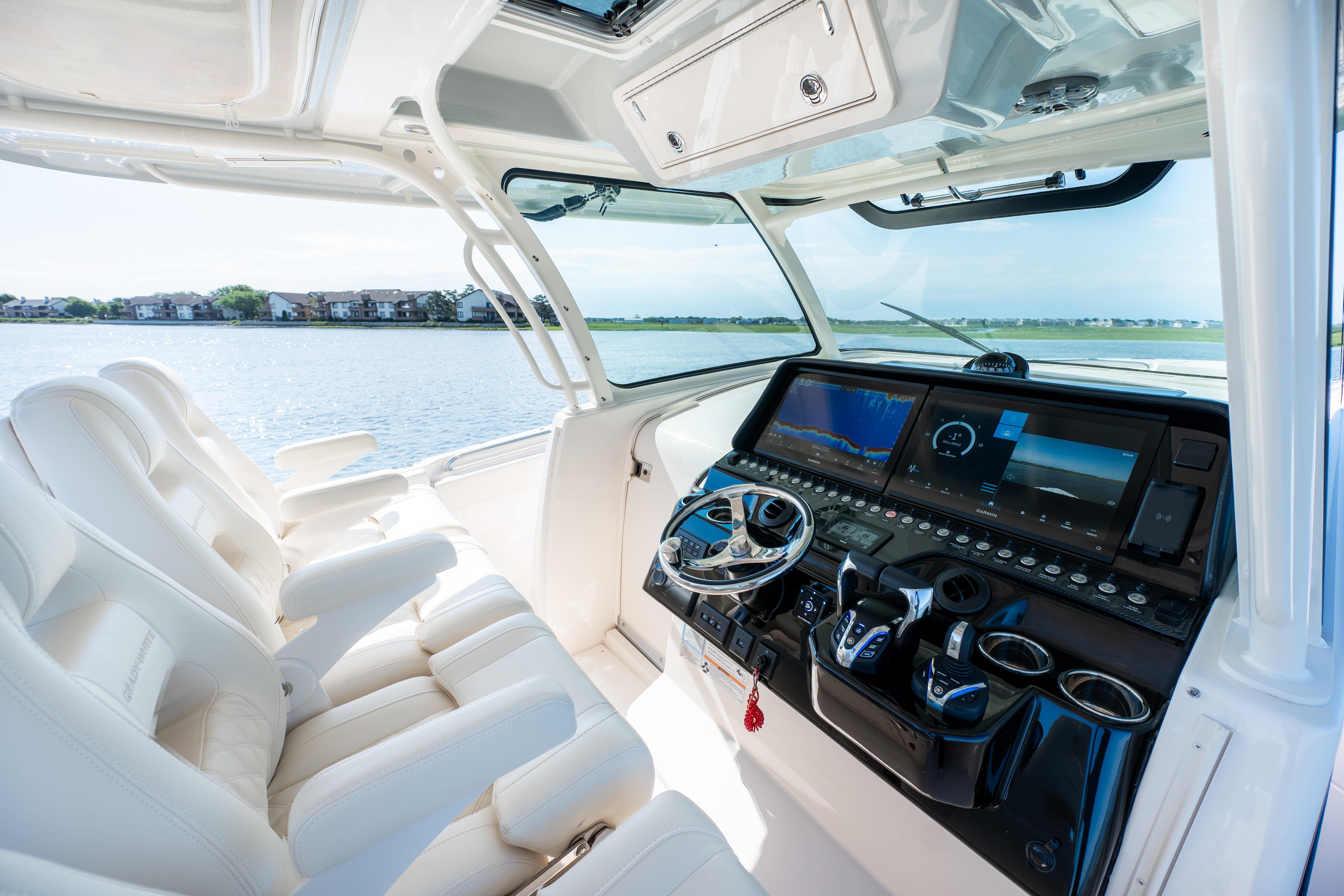 Luxurious 2025 Grady-White Canyon 386 boat interior with advanced navigation system and plush seating.