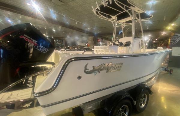 2024 Mako 214 CC center console boat on display with dual-axle trailer.