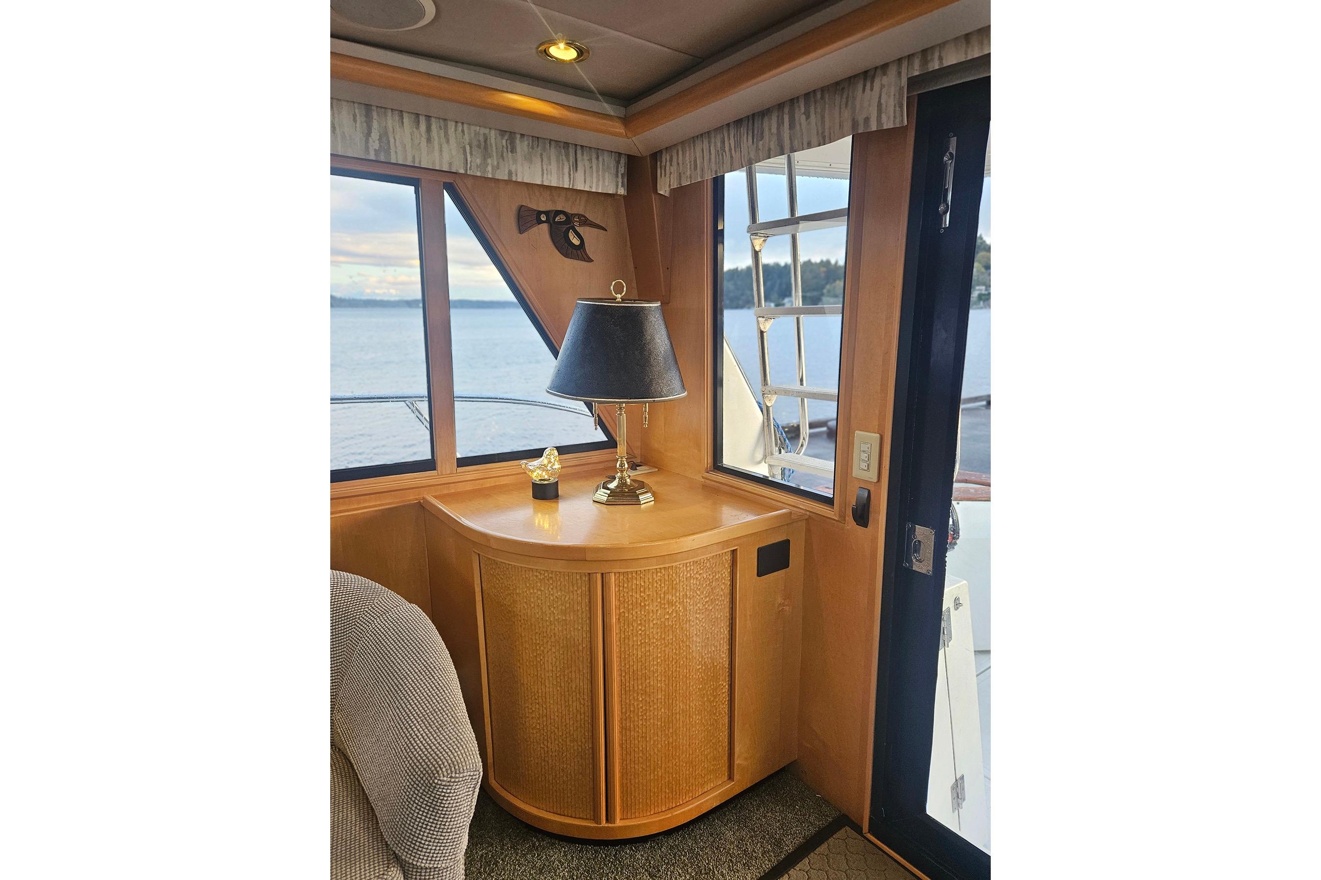 Interior of a 1995 Symbol 55 yacht with wooden cabinetry and ocean view.