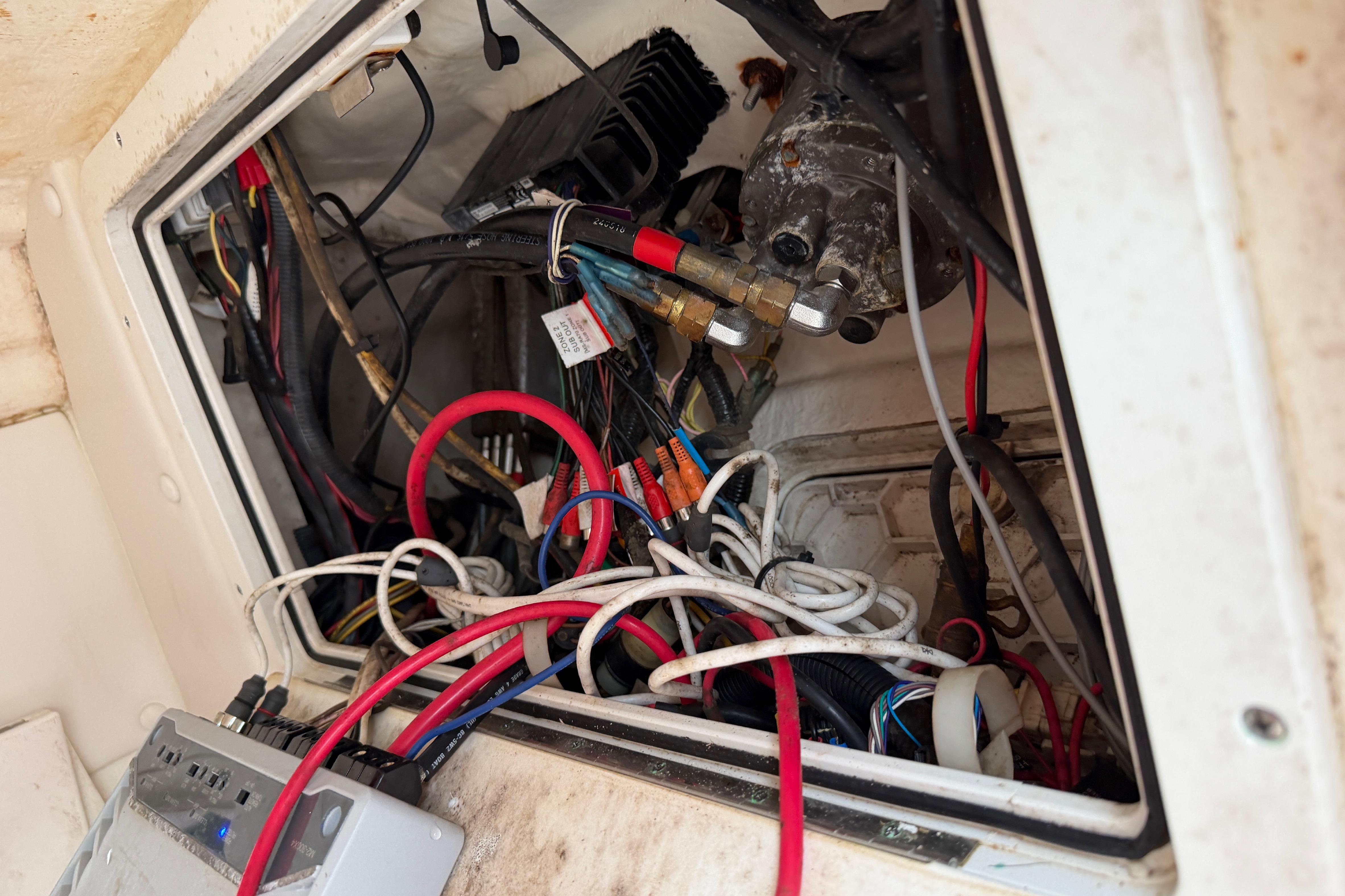Electrical wiring inside a 2019 World Cat 230 DC boat, showcasing complex cable arrangement.