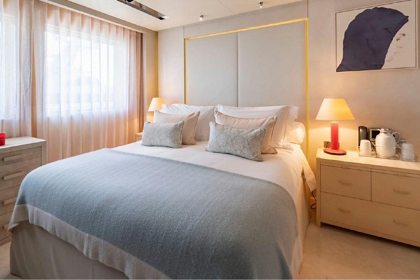 Luxurious yacht bedroom with elegant decor, soft lighting, and modern furnishings, Icon Motor Yacht 2010.