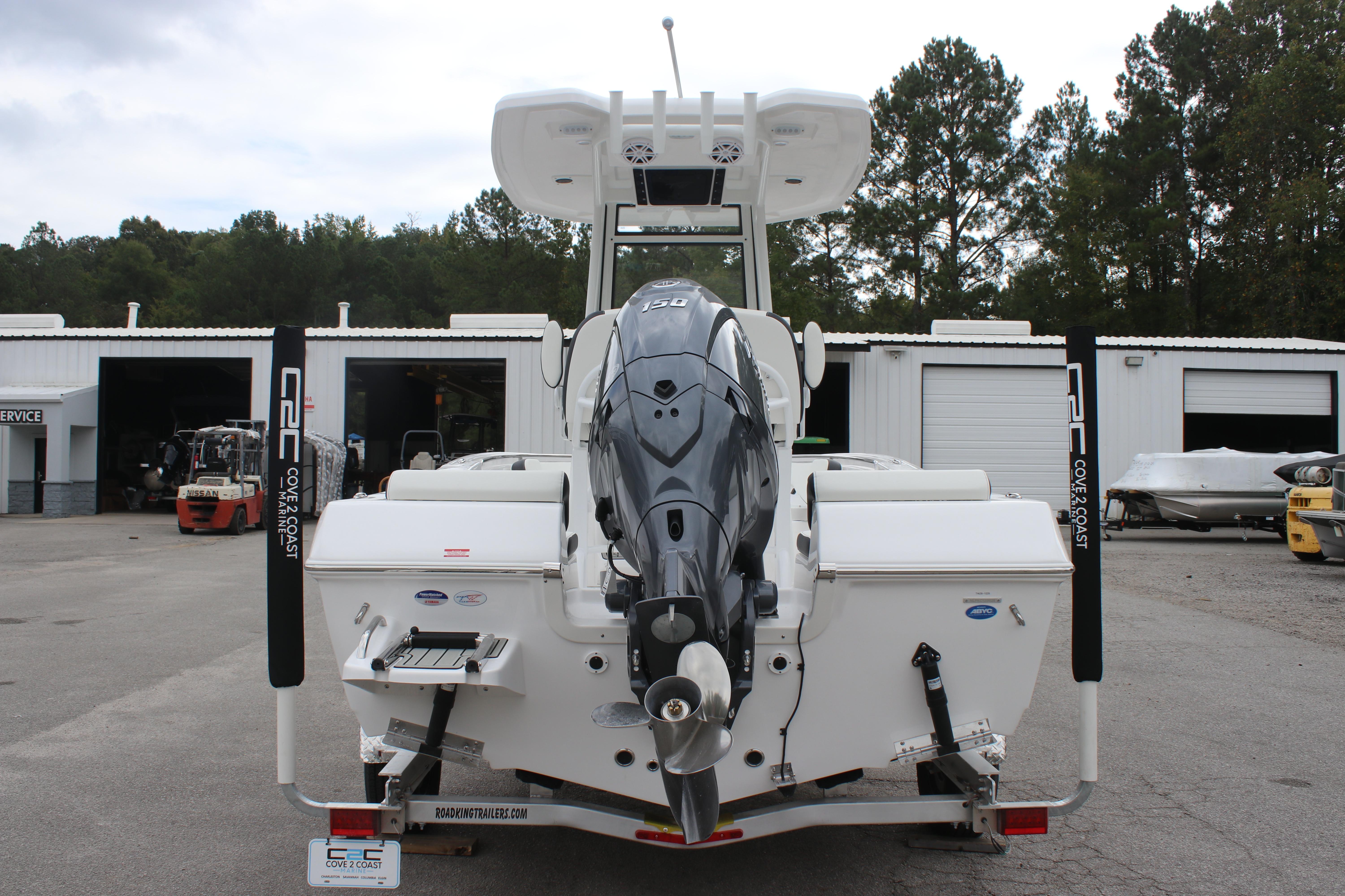 2026 Tidewater 198 CC Adventure boat with powerful outboard motor, parked at a service facility.