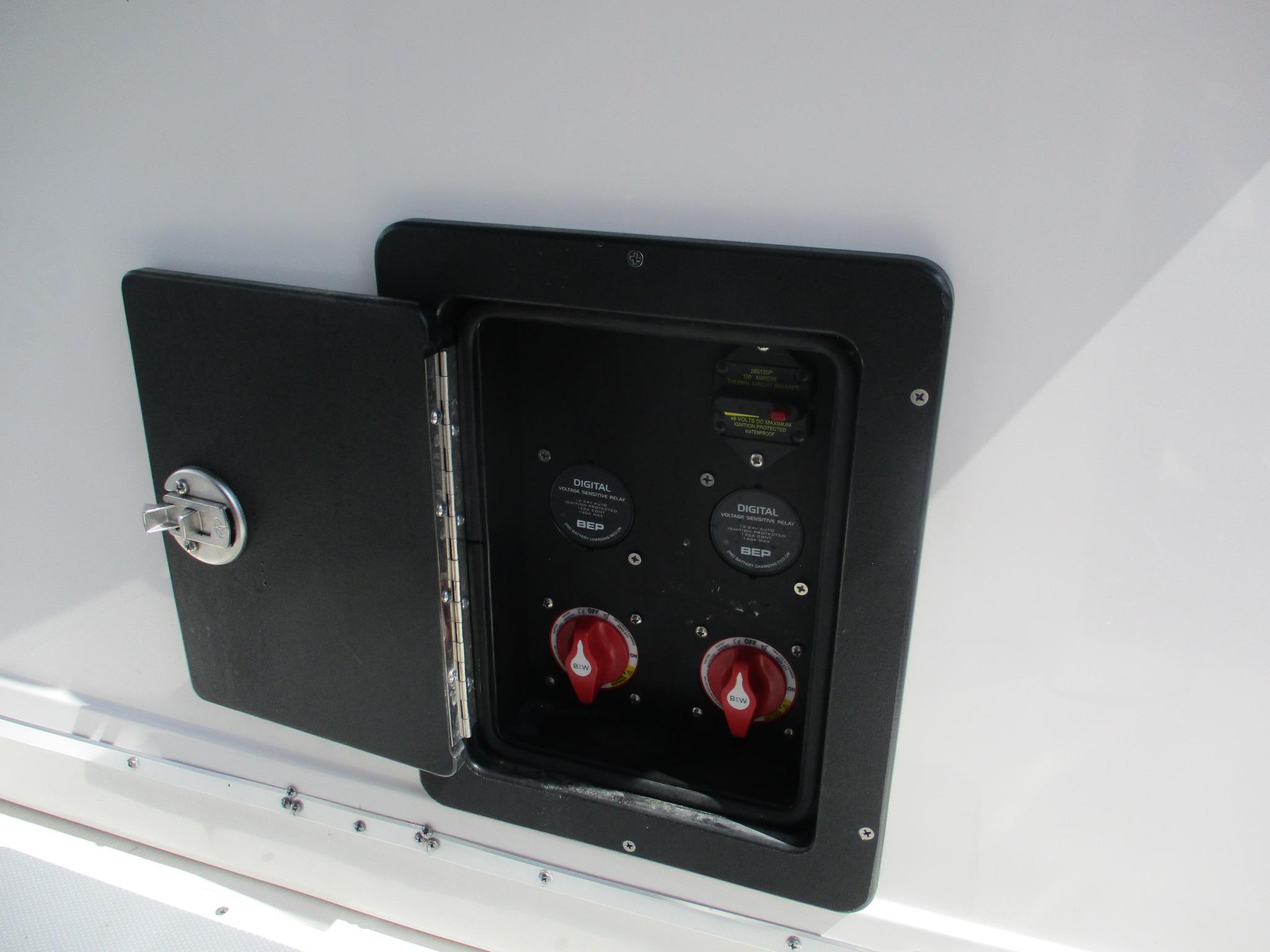 Electrical panel on 2024 Blue Wave 2800 Makaira boat, featuring digital controls and switches.