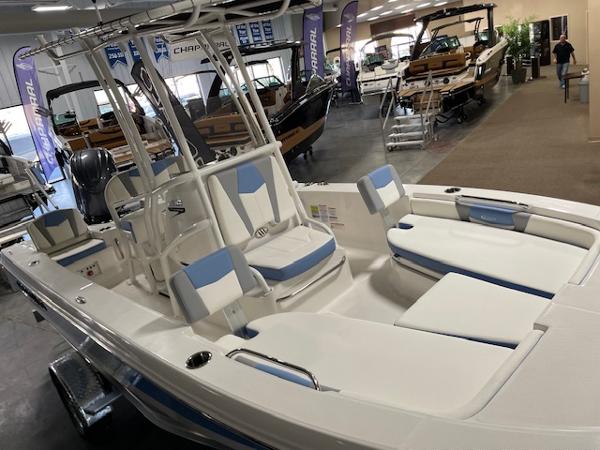 2025 Robalo 206 Cayman boat interior at a showroom, featuring white and blue seating.