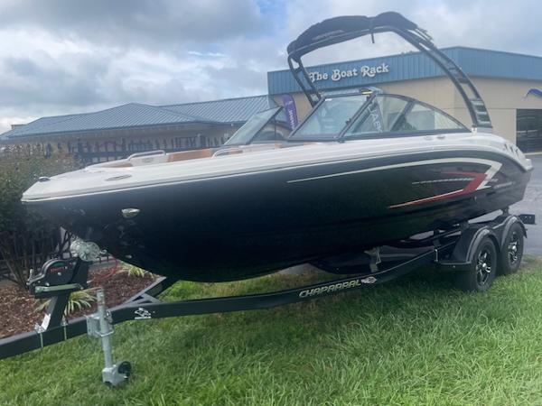 2025 Chaparral 21 SSi boat on trailer, displayed outdoors near dealership.