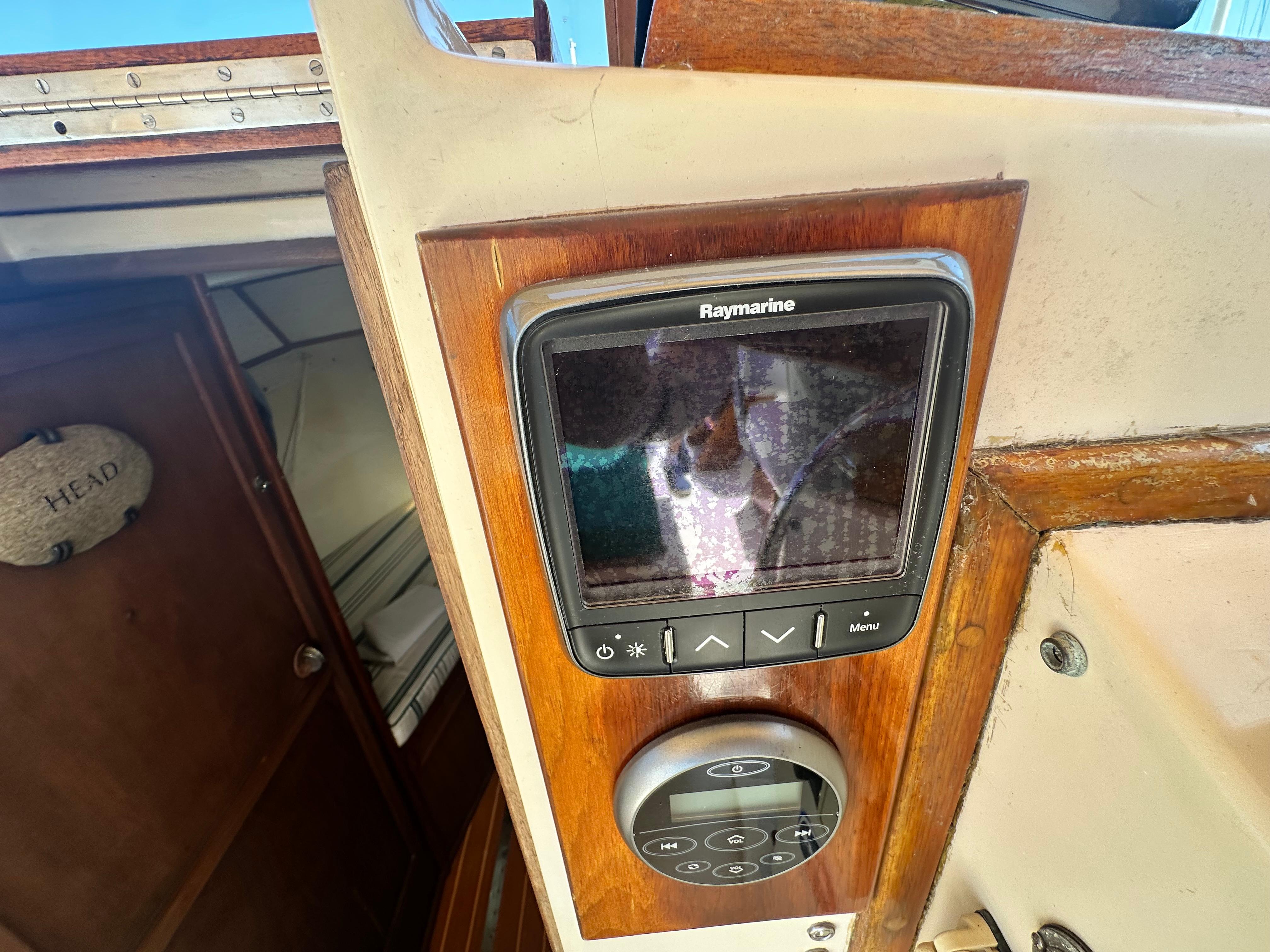 Raymarine navigation system on 1979 Fortier 26 boat, wooden interior detail.