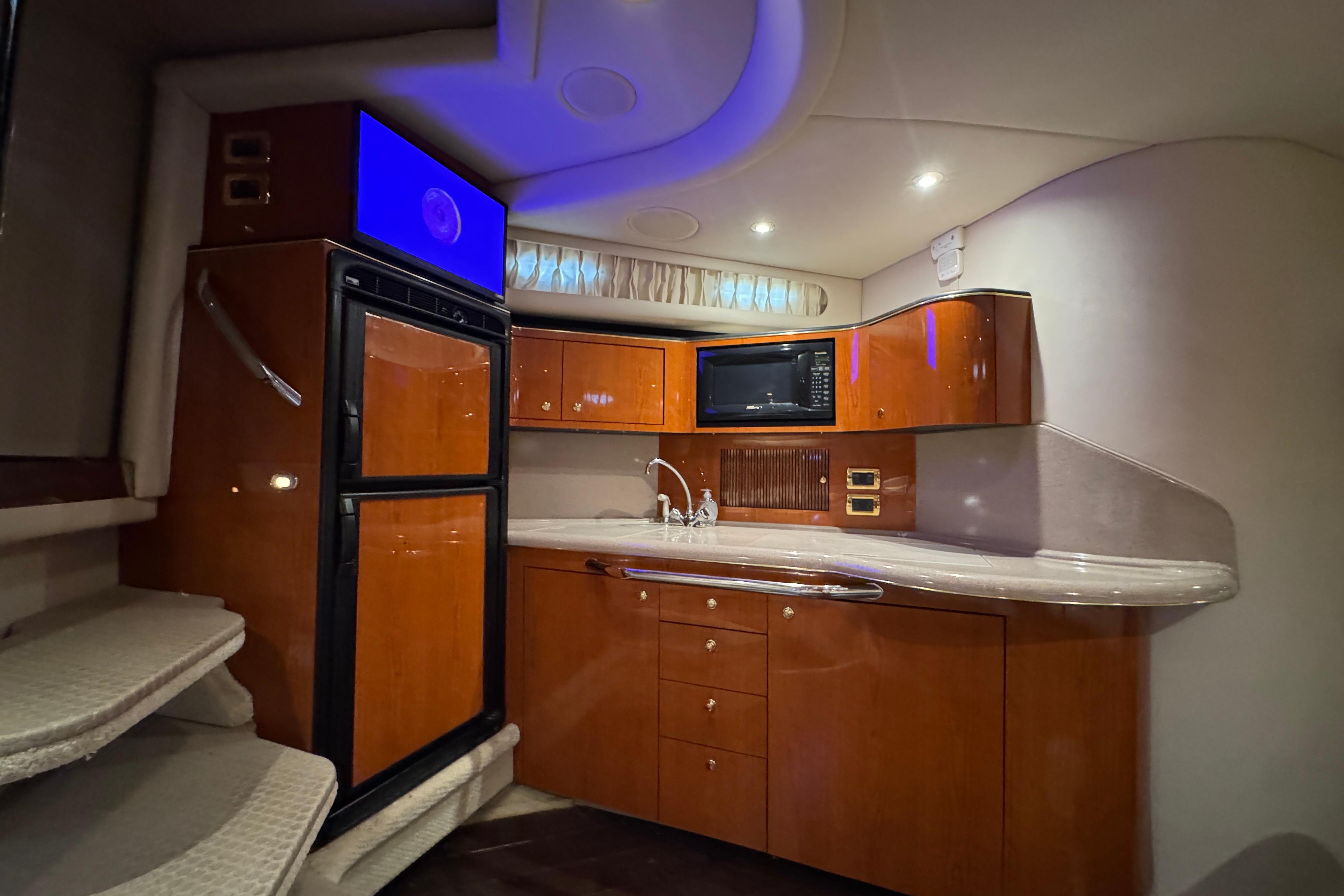 Luxurious 2001 Sea Ray 380 Sundancer yacht interior with modern kitchen amenities.