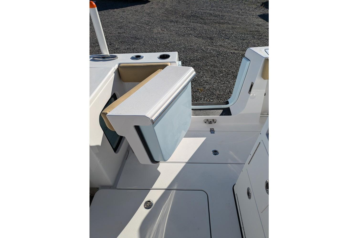 2025 Sportsman Open 282 Center Console boat interior, featuring a foldable seat and storage area.
