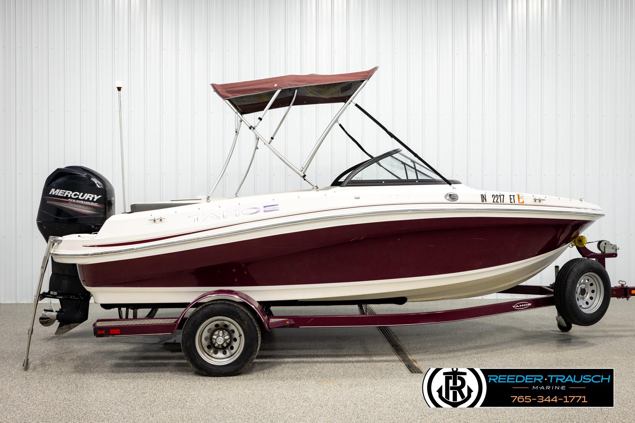 2016 Tahoe 450 TS boat with Mercury engine on trailer in showroom.