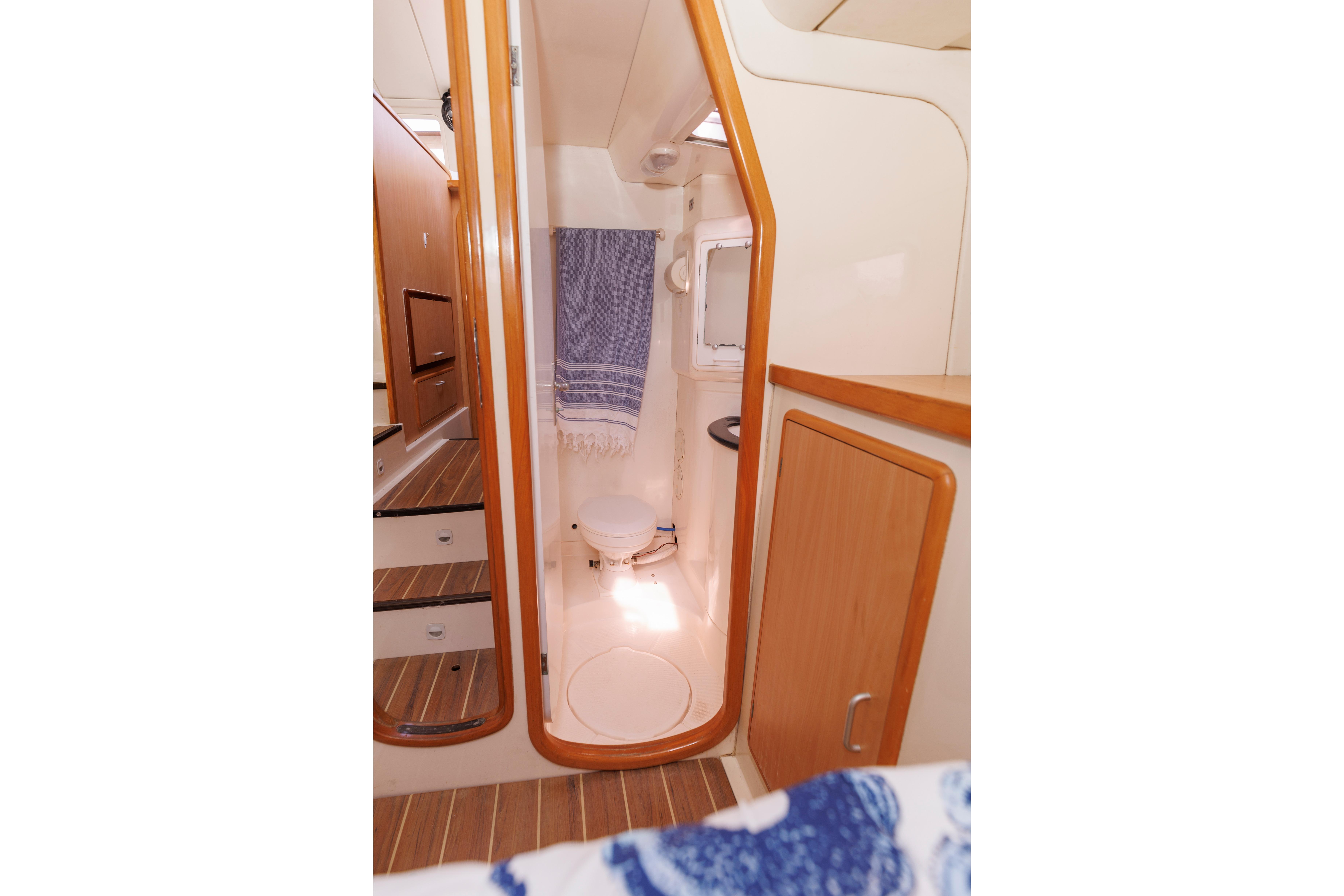 Interior of 2006 Leopard 43 yacht bathroom with wooden accents and compact design.