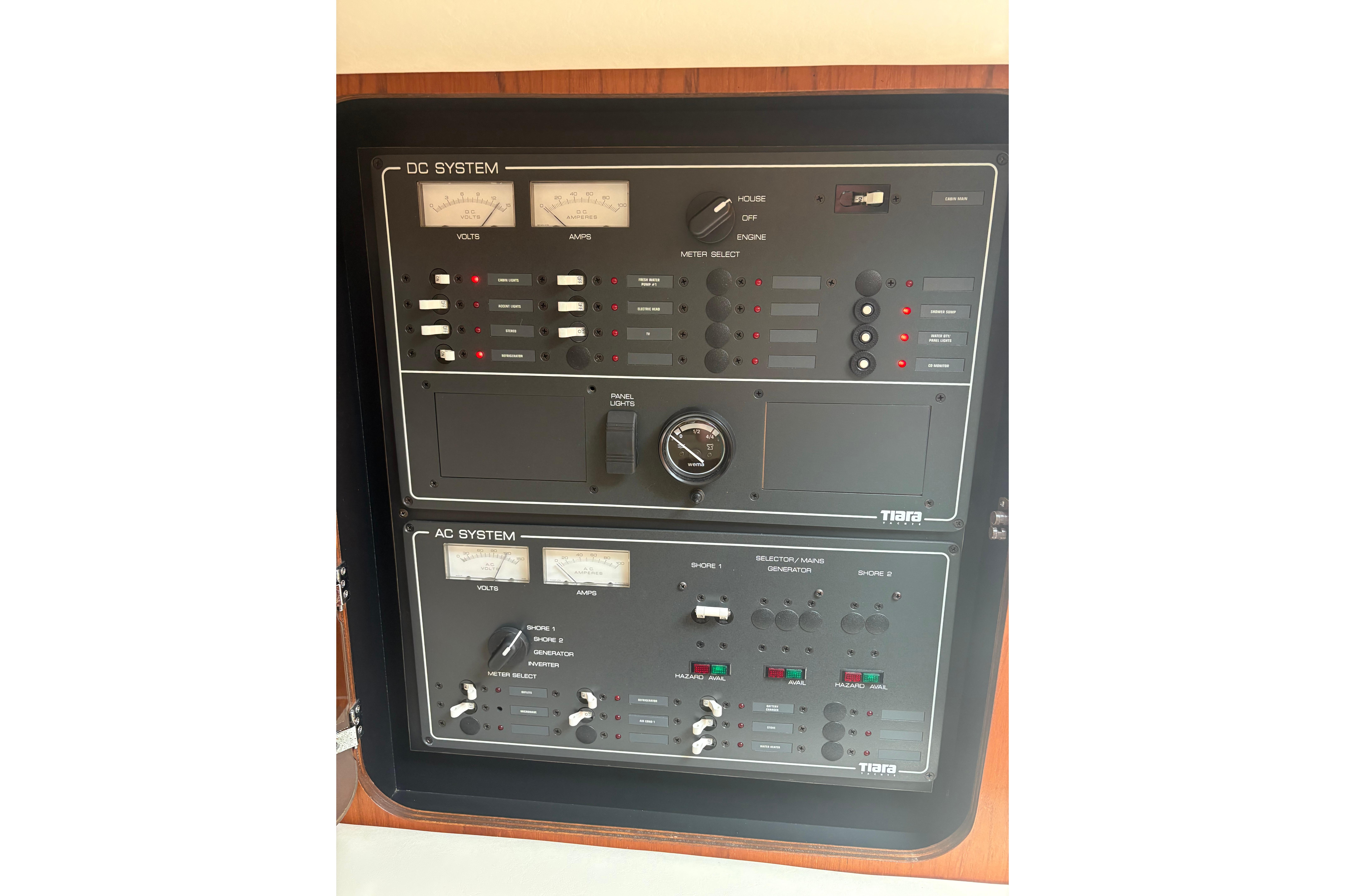 Electrical control panel of a 1999 Tiara Yachts 3100 Open, featuring DC and AC systems.