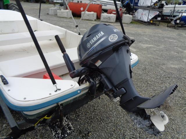 Small boat with Yamaha outboard motor, Sundance K14T model, 2010, on gravel surface.