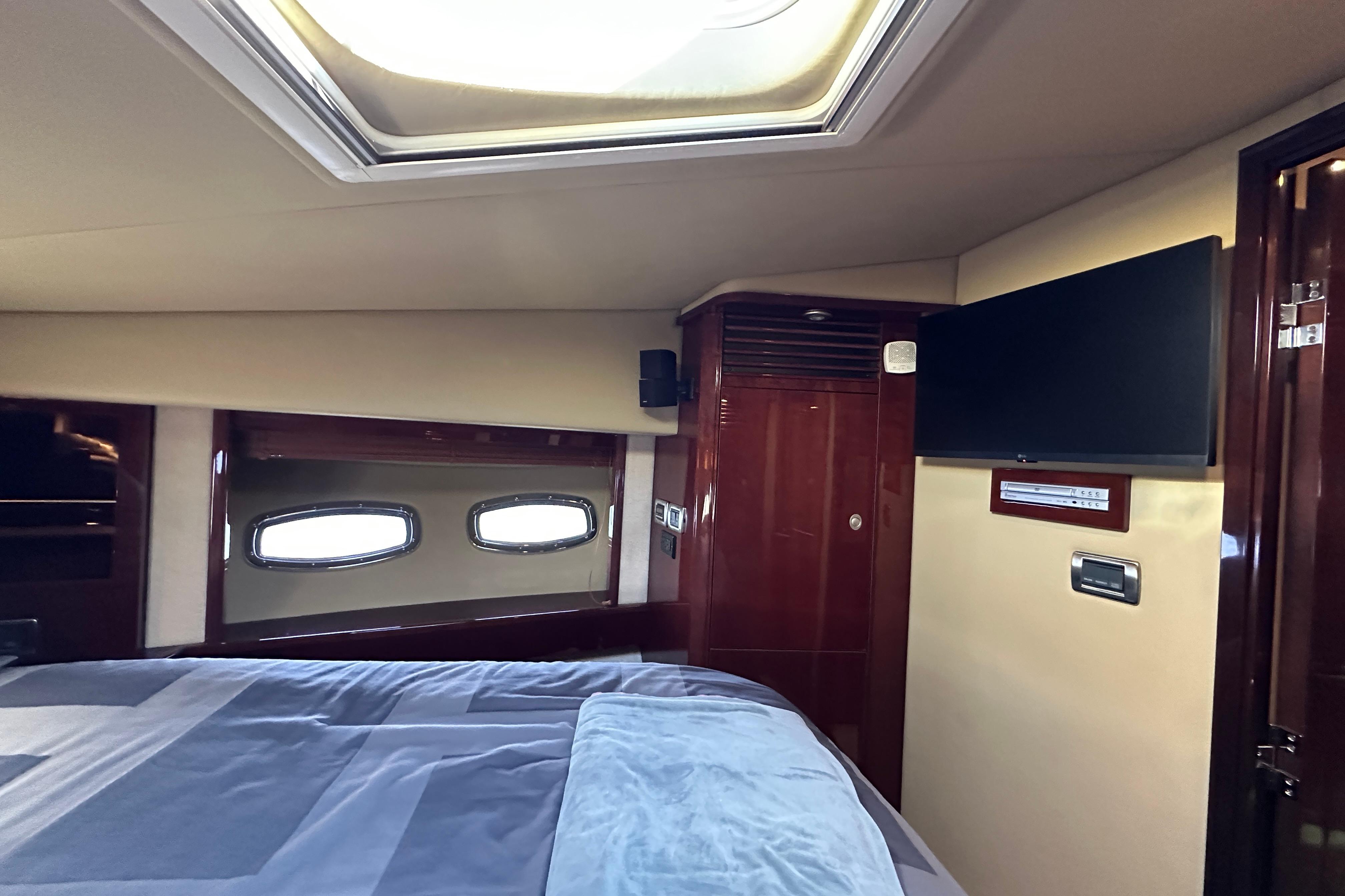 Luxurious cabin interior of 2007 Sea Ray 60 Sundancer yacht with skylight and TV.