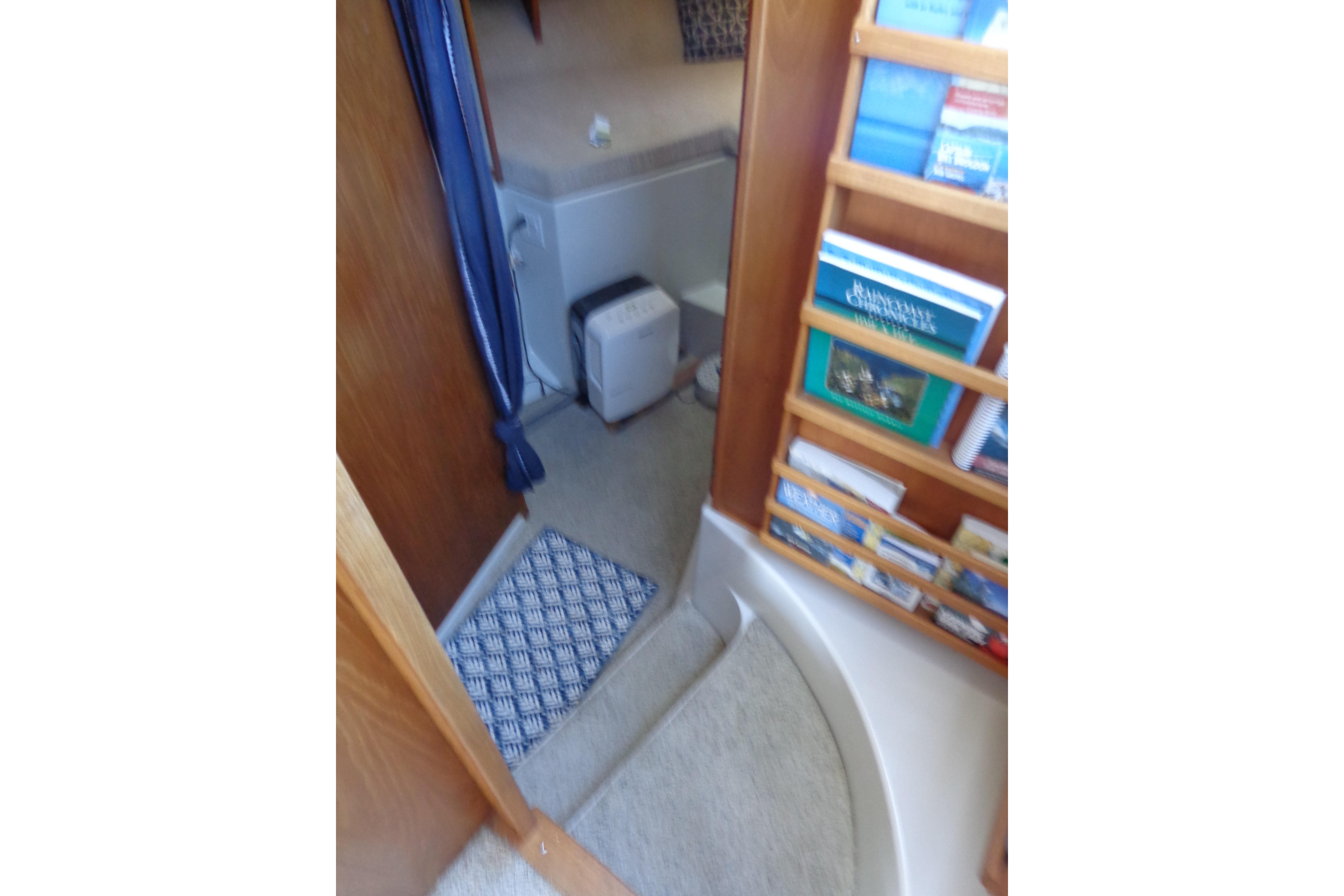 Interior of 1992 Cruise-A-Home Corsair 4200 with bookshelf and carpeted floor.