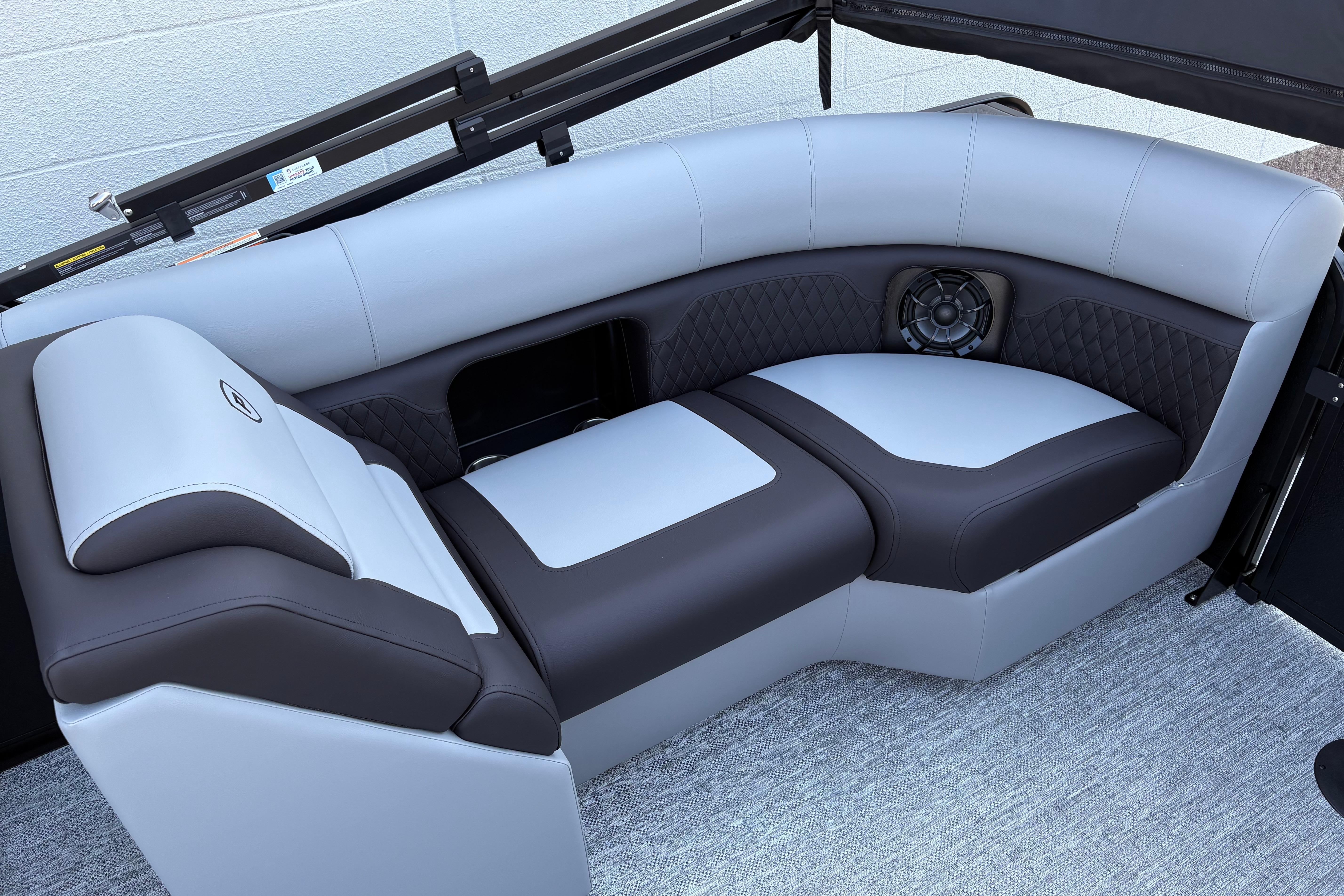 Luxurious seating on 2026 Premier 210 Sunsation RF boat, featuring sleek design and integrated speaker.