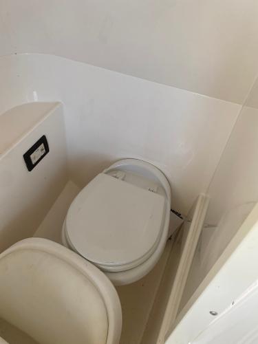 2015 Hurricane SunDeck 2400 OB boat bathroom interior with toilet.