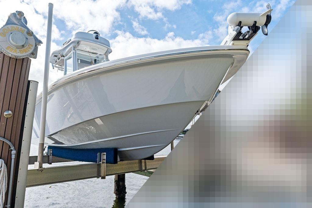 2023 Everglades 243 Center Console boat on a boat lift.
