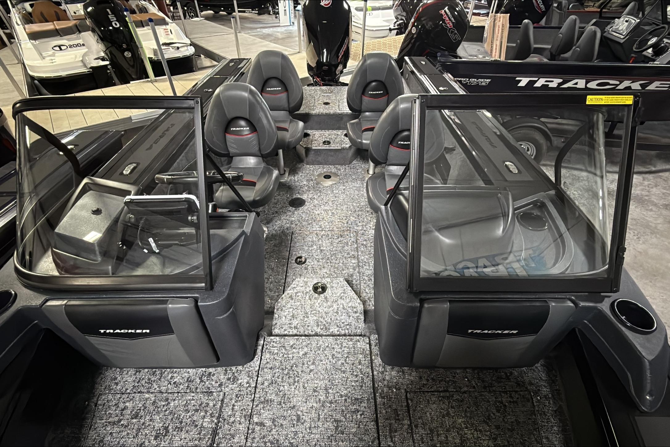2026 Tracker Targa V-18 WT boat interior with seating and windshield in showroom.