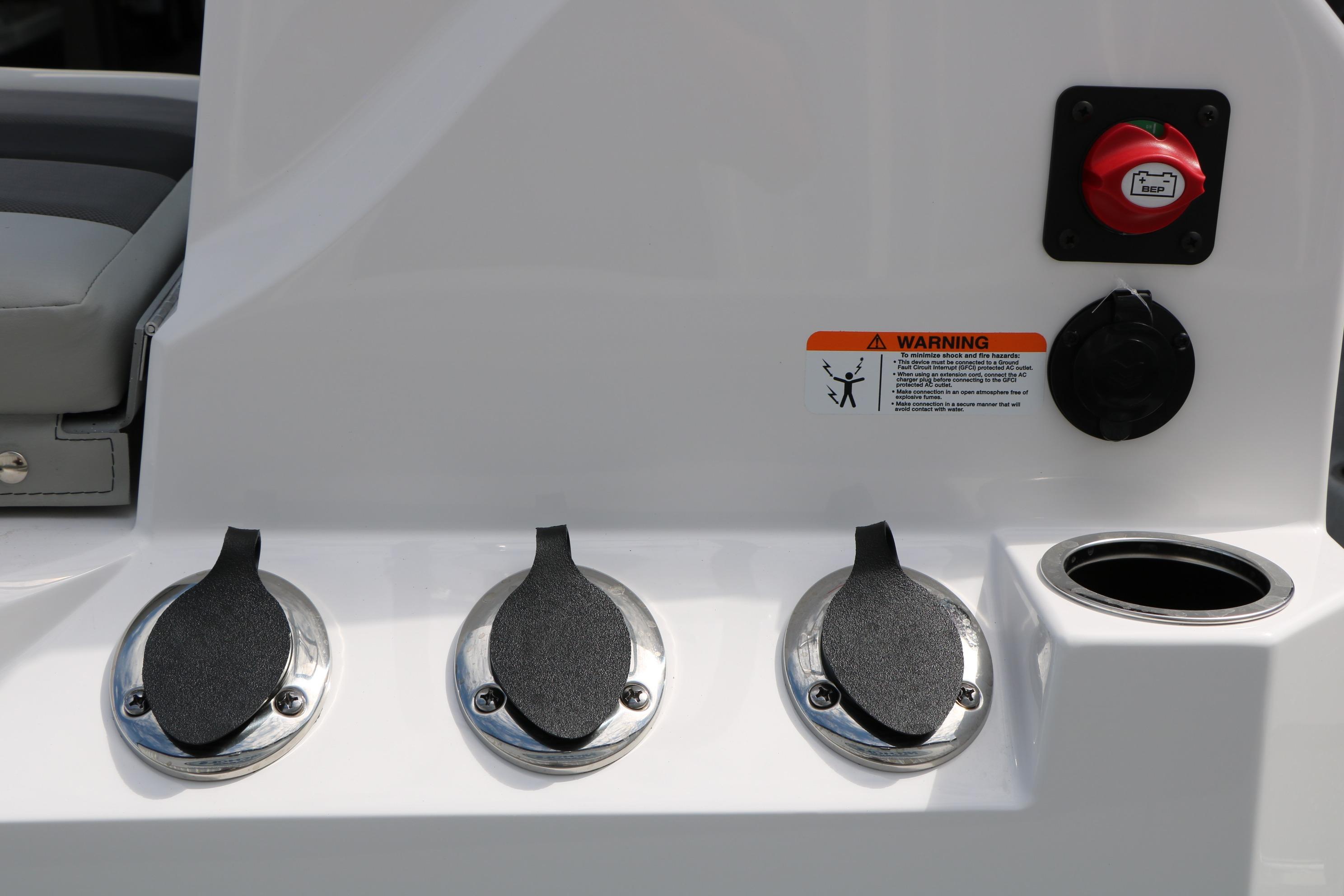 Control panel of 2026 Vexus Defender 201 boat with warning label and switches.