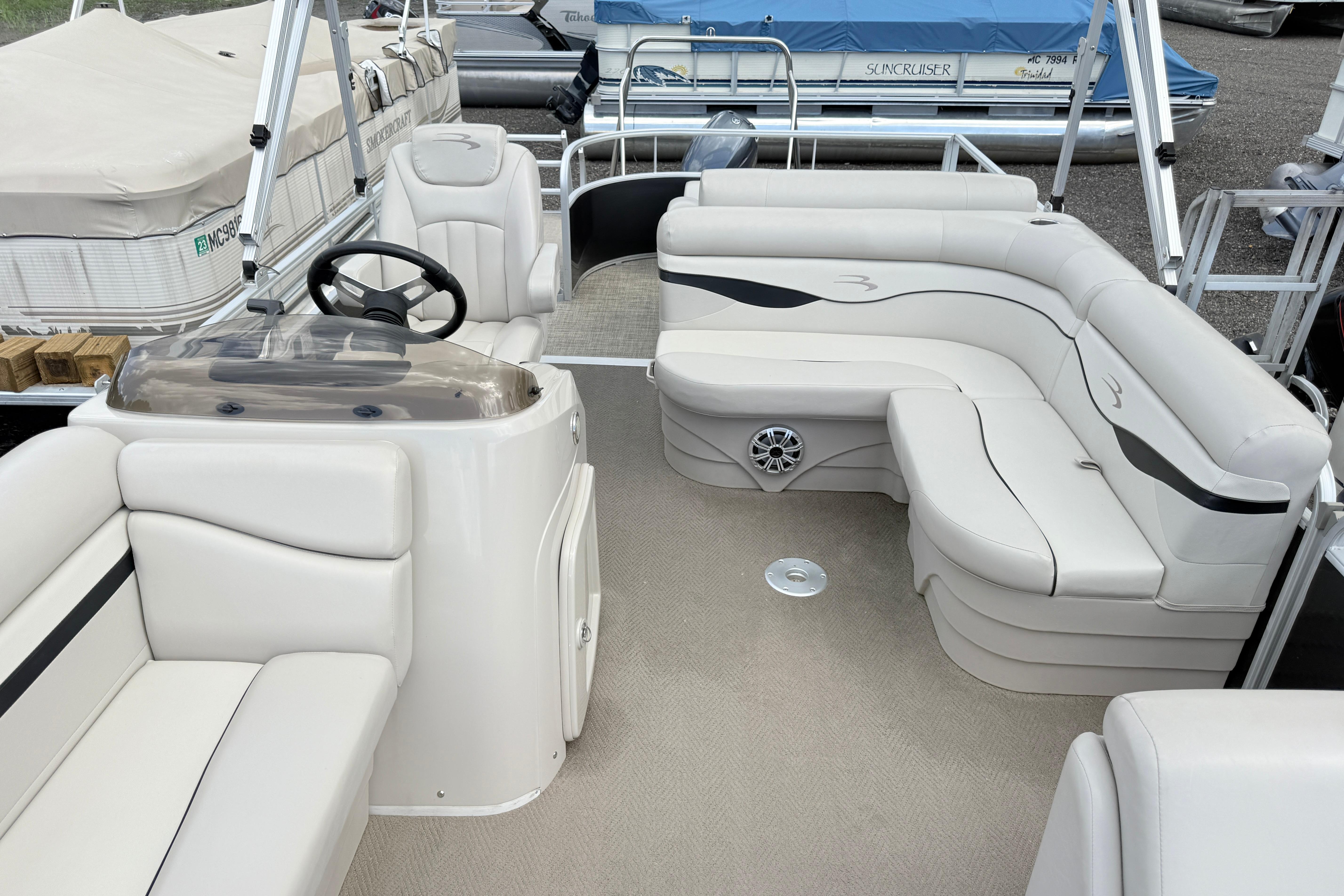 2015 Bennington 24SSLX pontoon boat interior with plush seating and steering console.