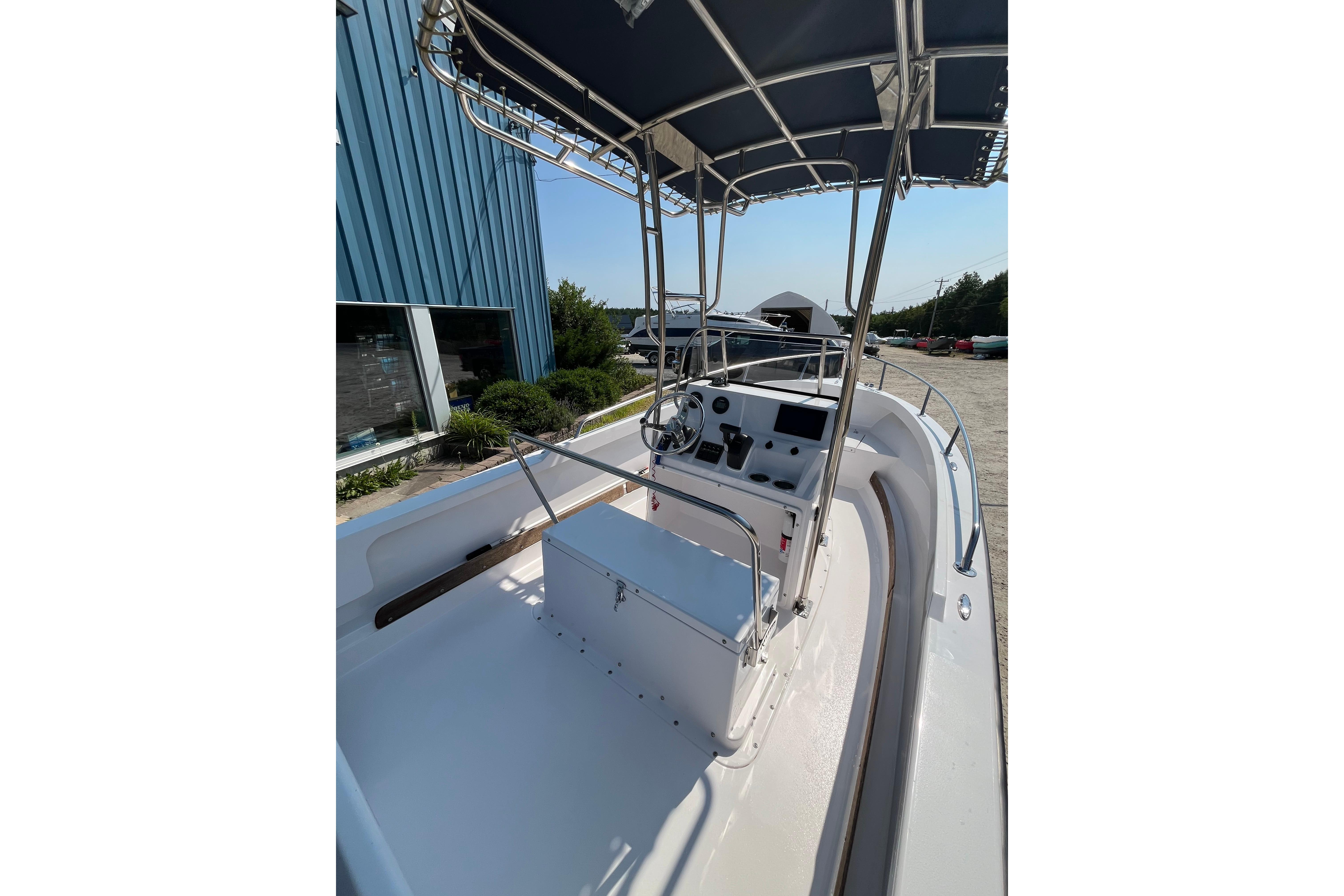 2021 Rossiter 17 CC boat interior with steering console and canopy.