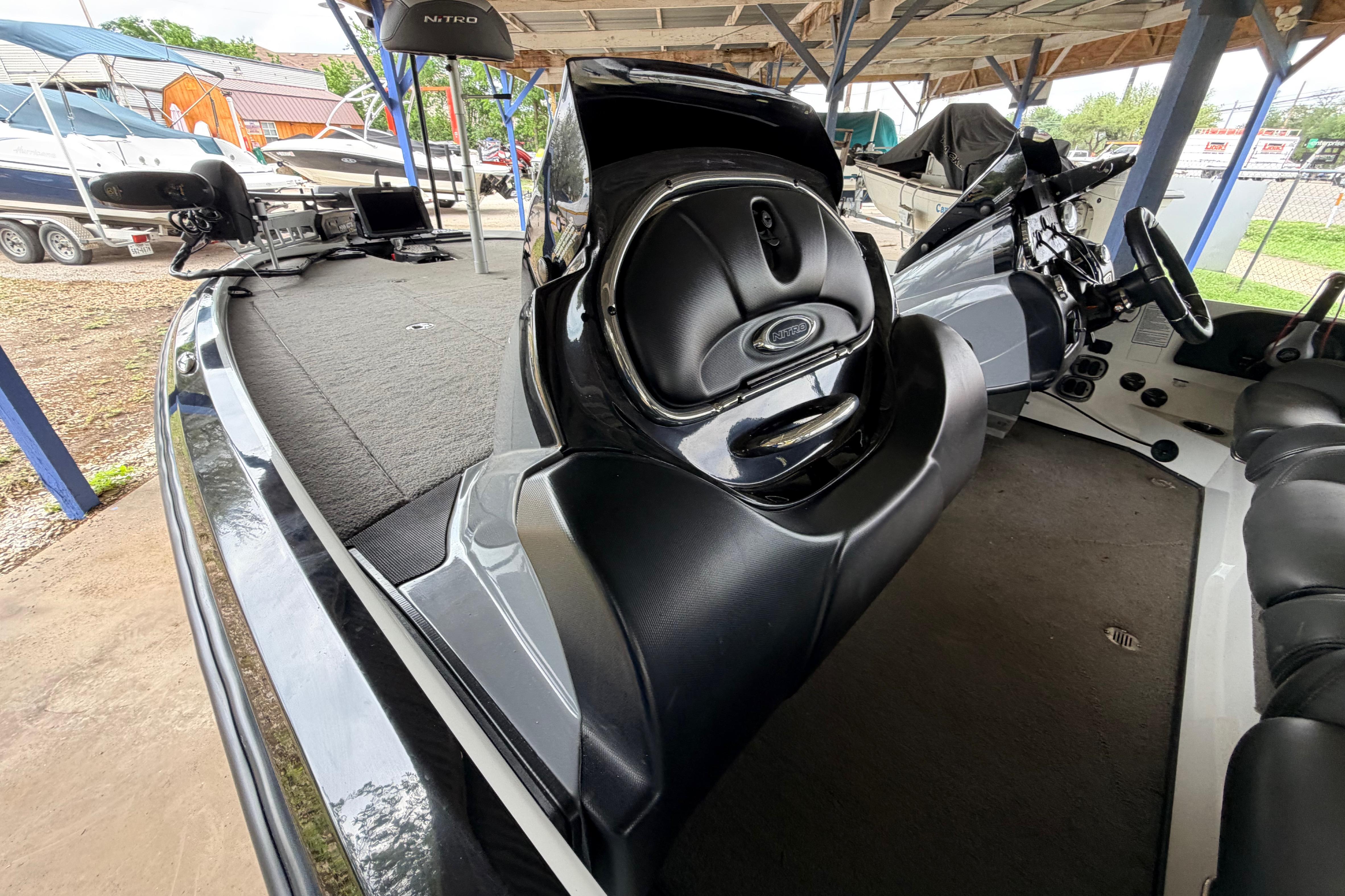 2016 Nitro Z20 boat interior with steering console and seating under a covered area.