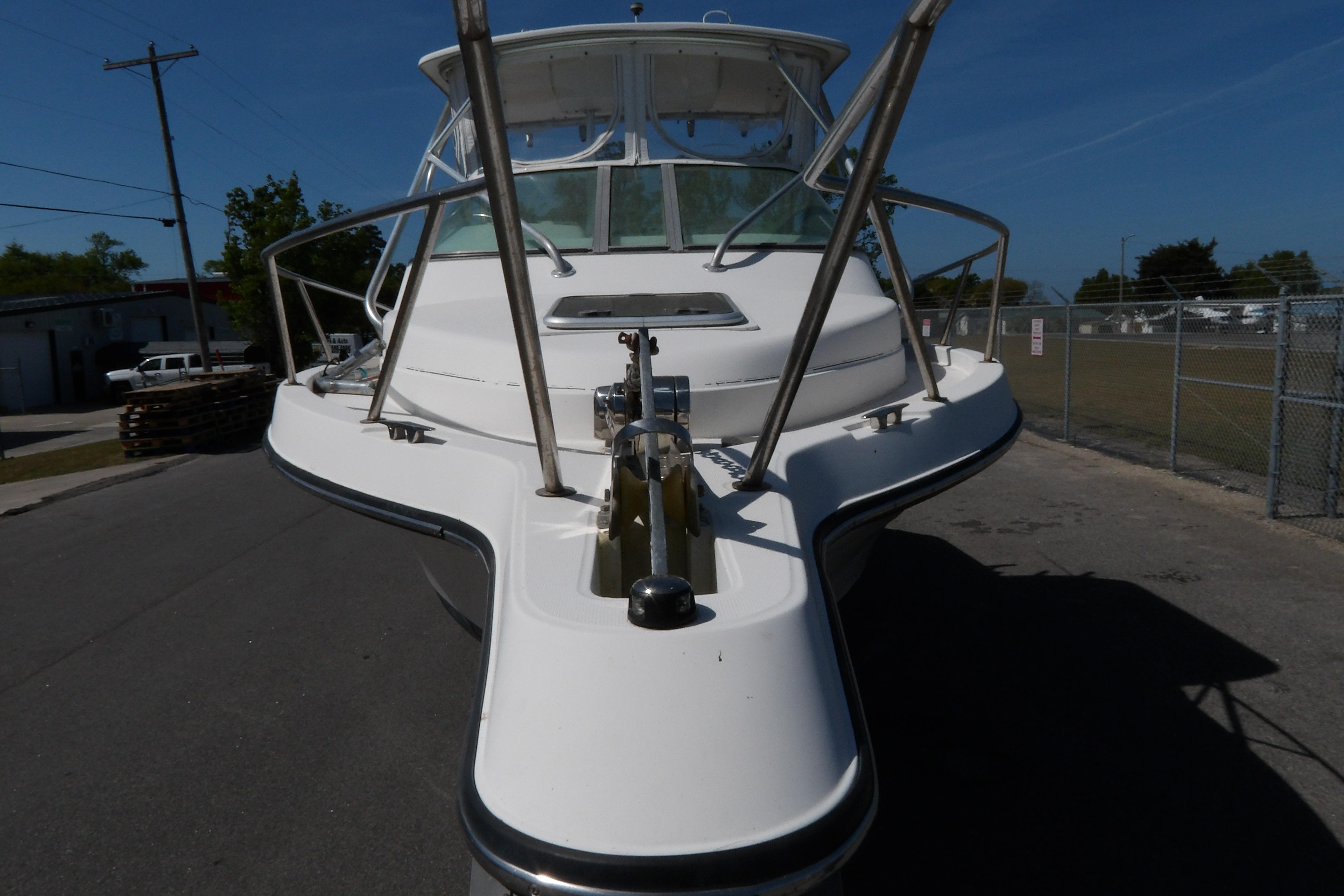1993 Wahoo 2600 boat on pavement, front view with railings and anchor.