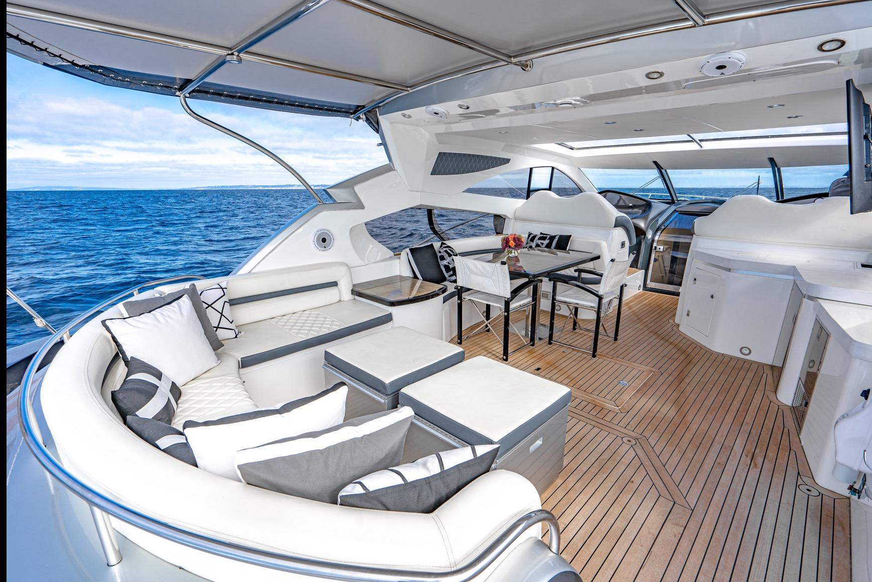 Luxurious Sunseeker Predator 68 yacht interior, 2021 model, featuring elegant seating and ocean view.