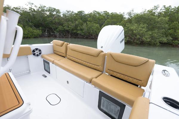 Manufacturer Provided Image: 2025 Sportsman Heritage 231 Center Console boat with tan seating, near lush mangroves.