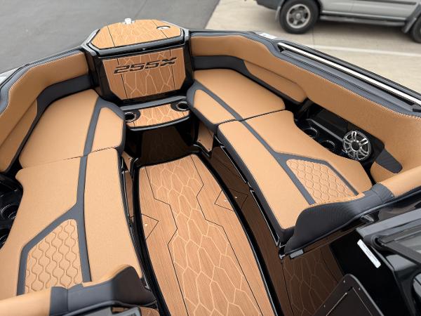 2025 Yamaha Boats 255XD interior with tan and black seating, showcasing luxury design.