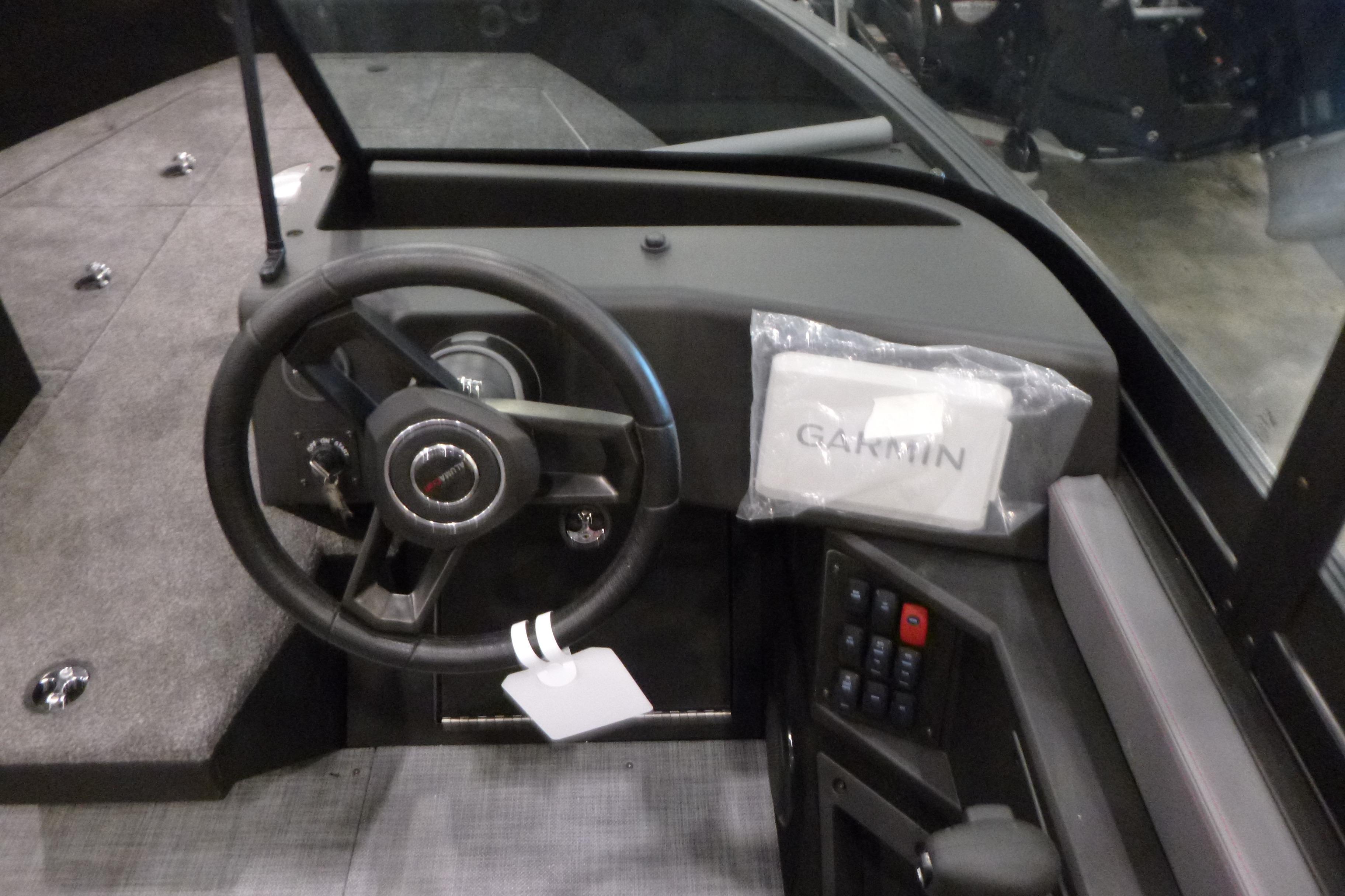 2025 Alumacraft Trophy 185X Sport boat dashboard with steering wheel and Garmin device.