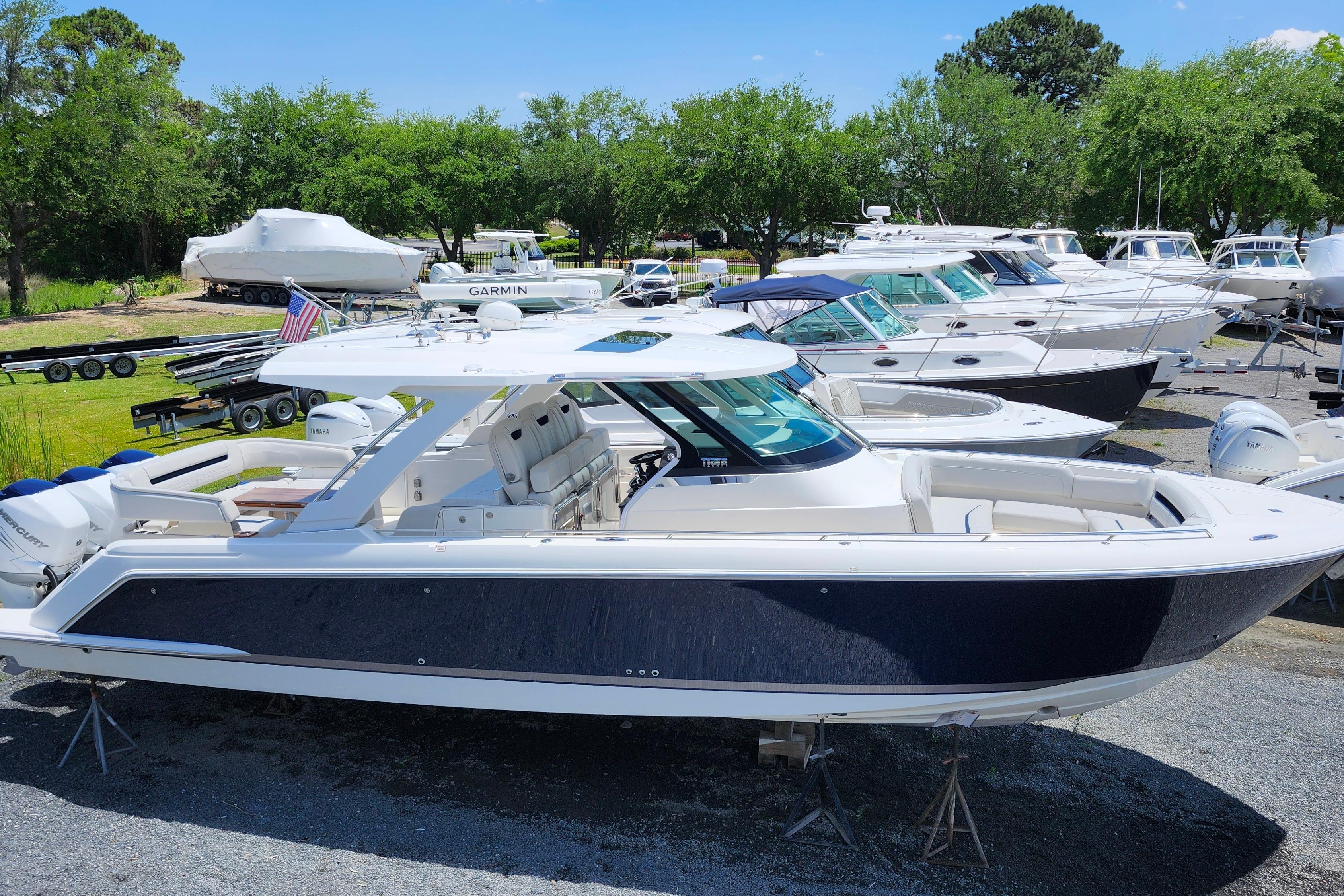 2022 Tiara Yachts 38 LS boat displayed in a marina with other vessels.