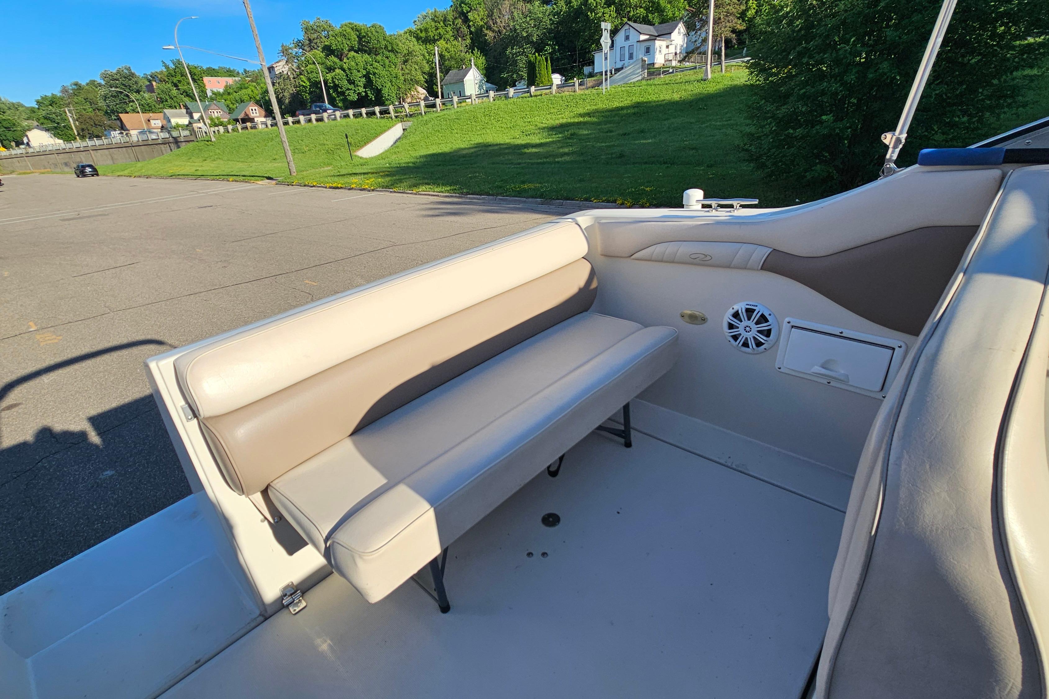 Interior of a 1999 Regal Commodore 258 boat with beige seating and speaker.