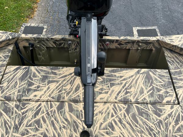 2024 Lowe Roughneck 1660 boat with camo pattern and outboard motor.